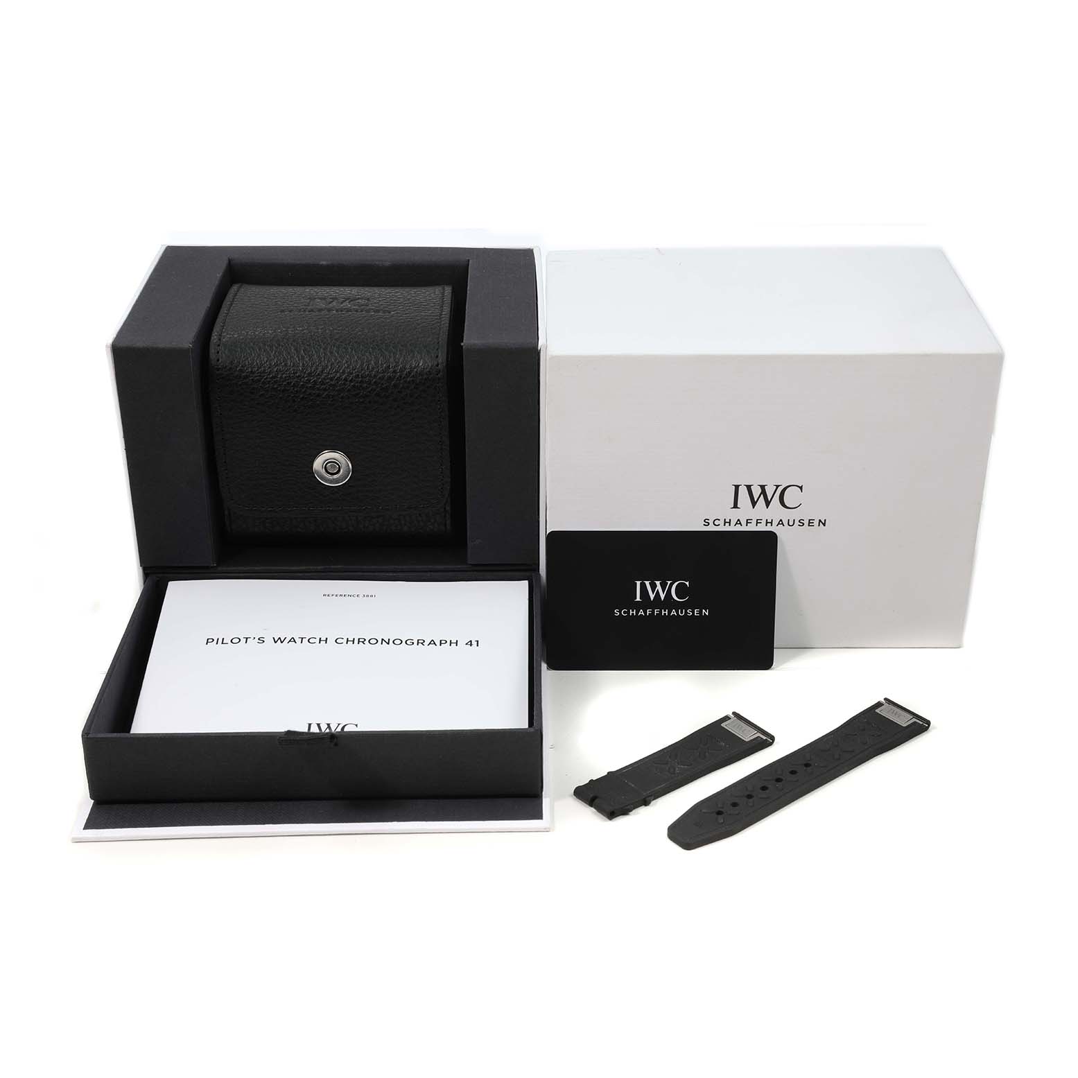The image shows an IWC Pilot IW388106 Men's Titanium Black Dial's watch box, booklet, card, and two black straps, viewed from the front.