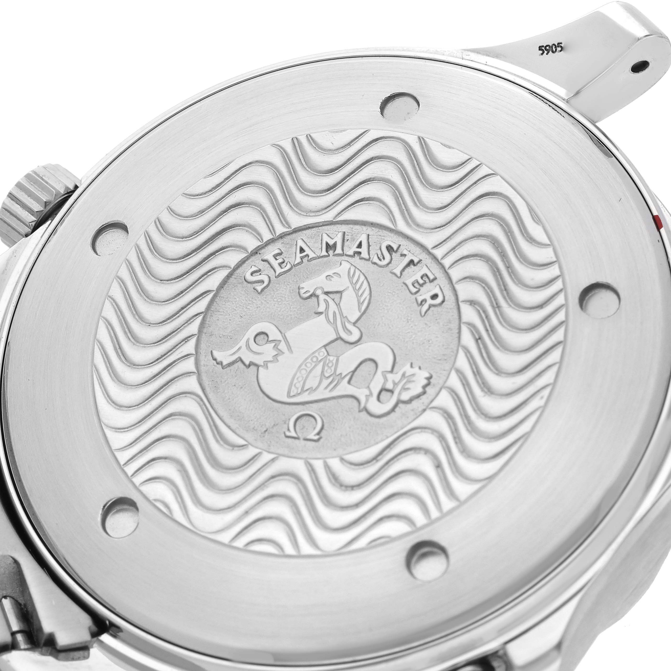 The image shows the back of the Omega Seamaster 2541.80.00 Men
s Stainless Steel Blue Dial 2541.80.00 Men
s Stainless Steel Blue Dial watch, featuring the engraved emblem and wavy pattern.