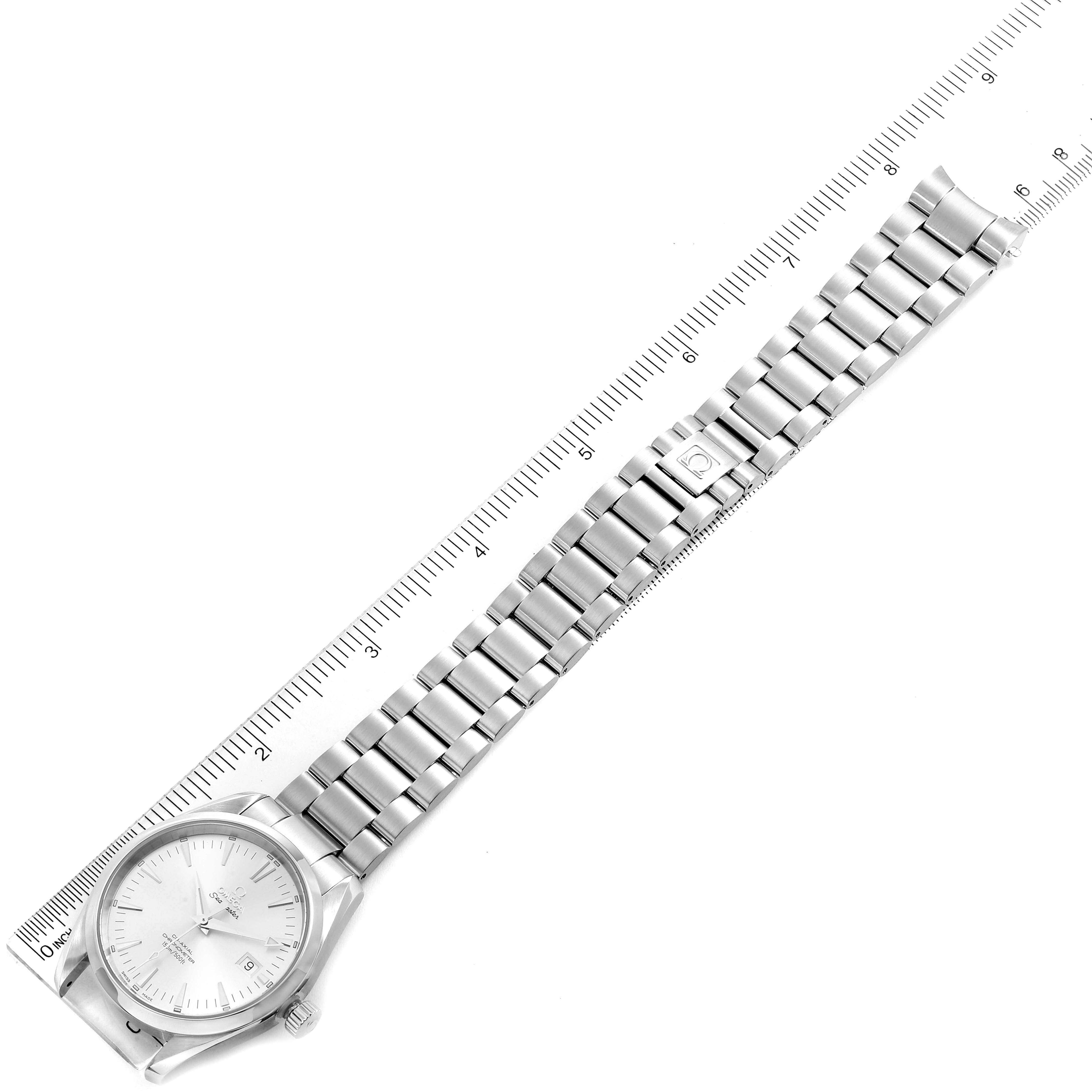The Omega Aqua Terra 2503.30.00 Men
s Stainless Steel Silver Dial 2503.30.00 Men
s Stainless Steel Silver Dial watch is shown from a top-down angle, displaying the watch face and fully extended metal bracelet alongside a ruler.