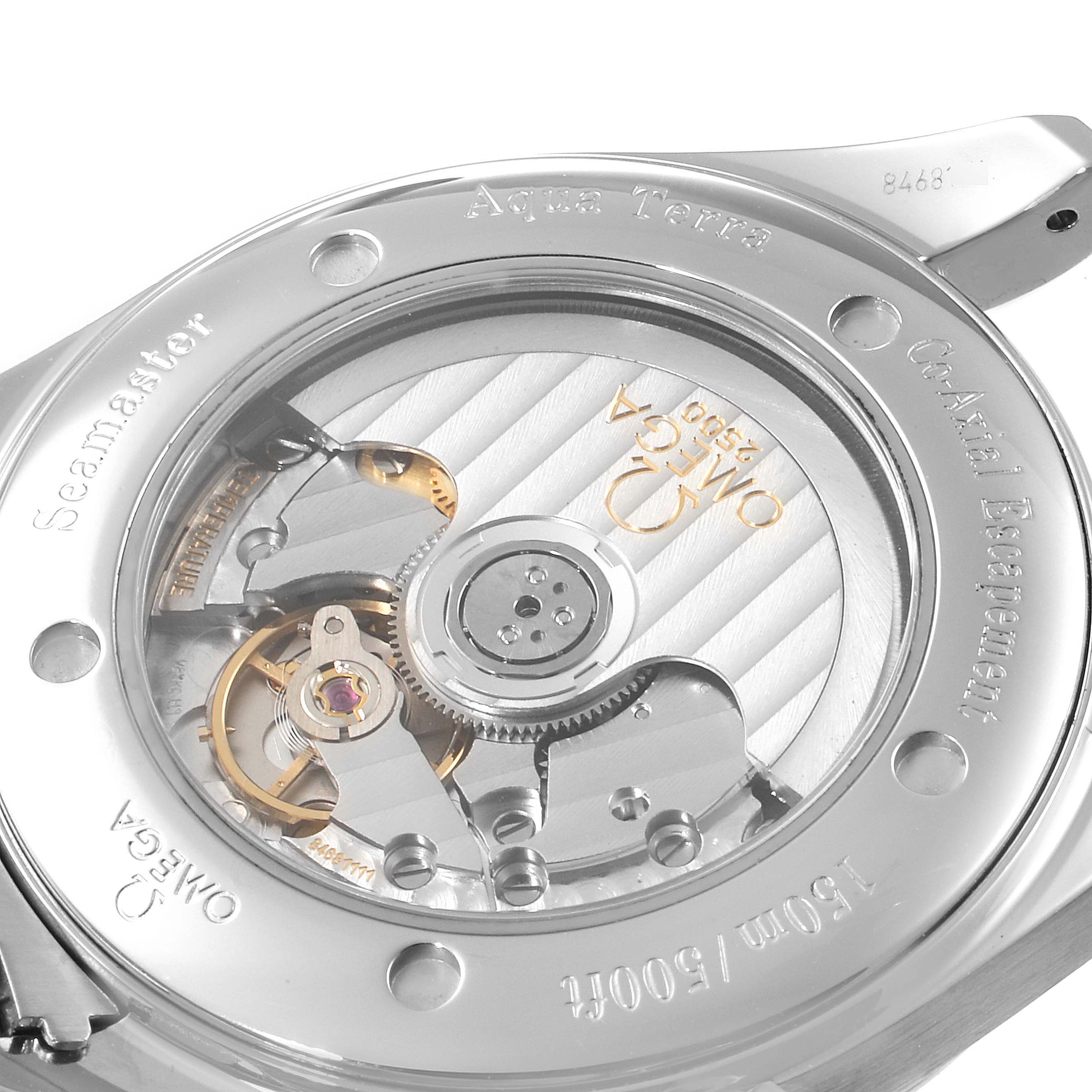 The image shows the back of the Omega Aqua Terra 2503.30.00 Men
s Stainless Steel Silver Dial 2503.30.00 Men
s Stainless Steel Silver Dial watch, displaying the co-axial movement and engravings on the case.