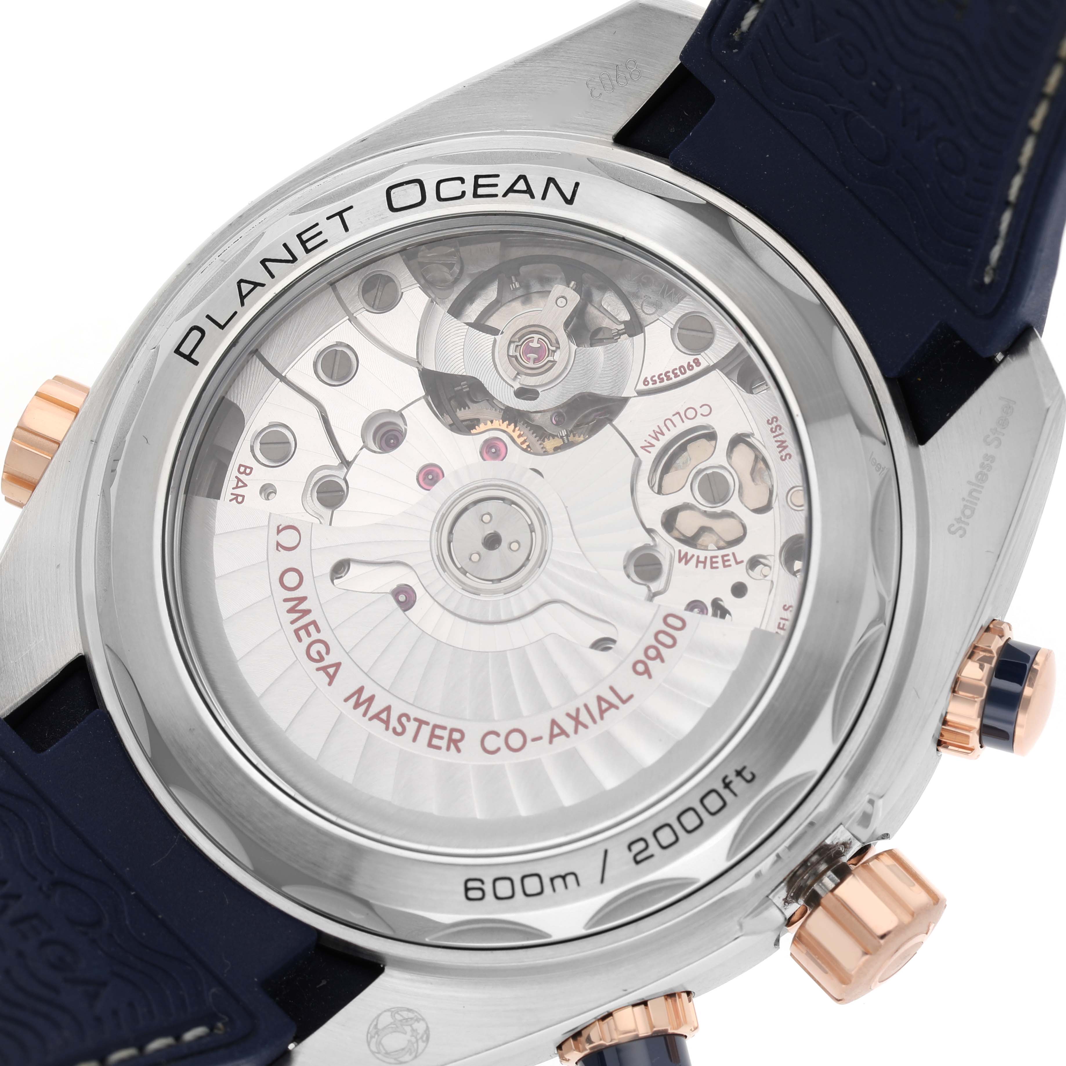 The image shows the back of the Omega Planet Ocean 215.23.46.51.03.001 Men's Steel and Gold (two tone) Blue Dial watch, highlighting its transparent case back and internal mechanics.