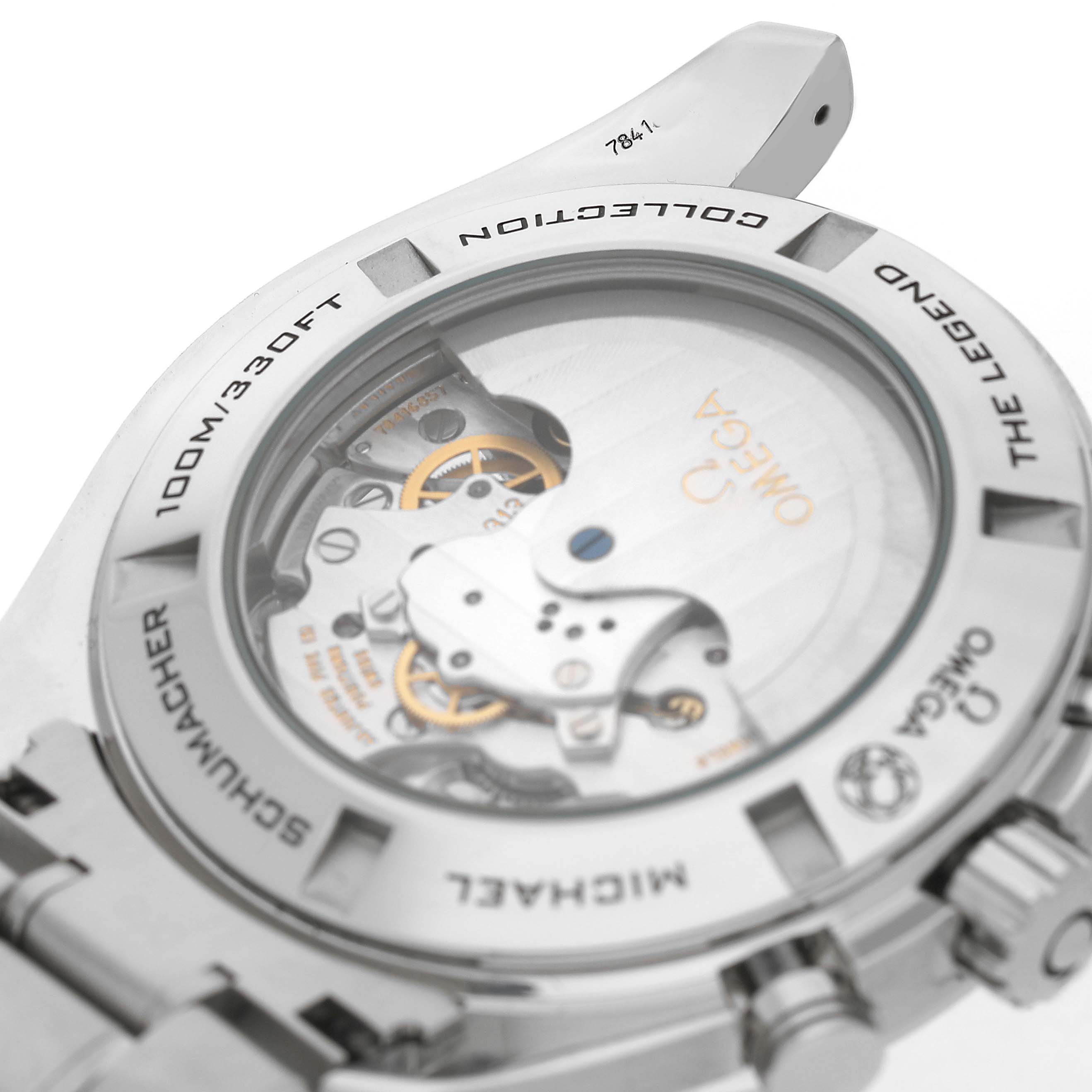 The image shows the back of the Omega Speedmaster 321.30.44.50.01.001 Men's Stainless Steel Black Dial, highlighting its transparent case back and internal movement components.