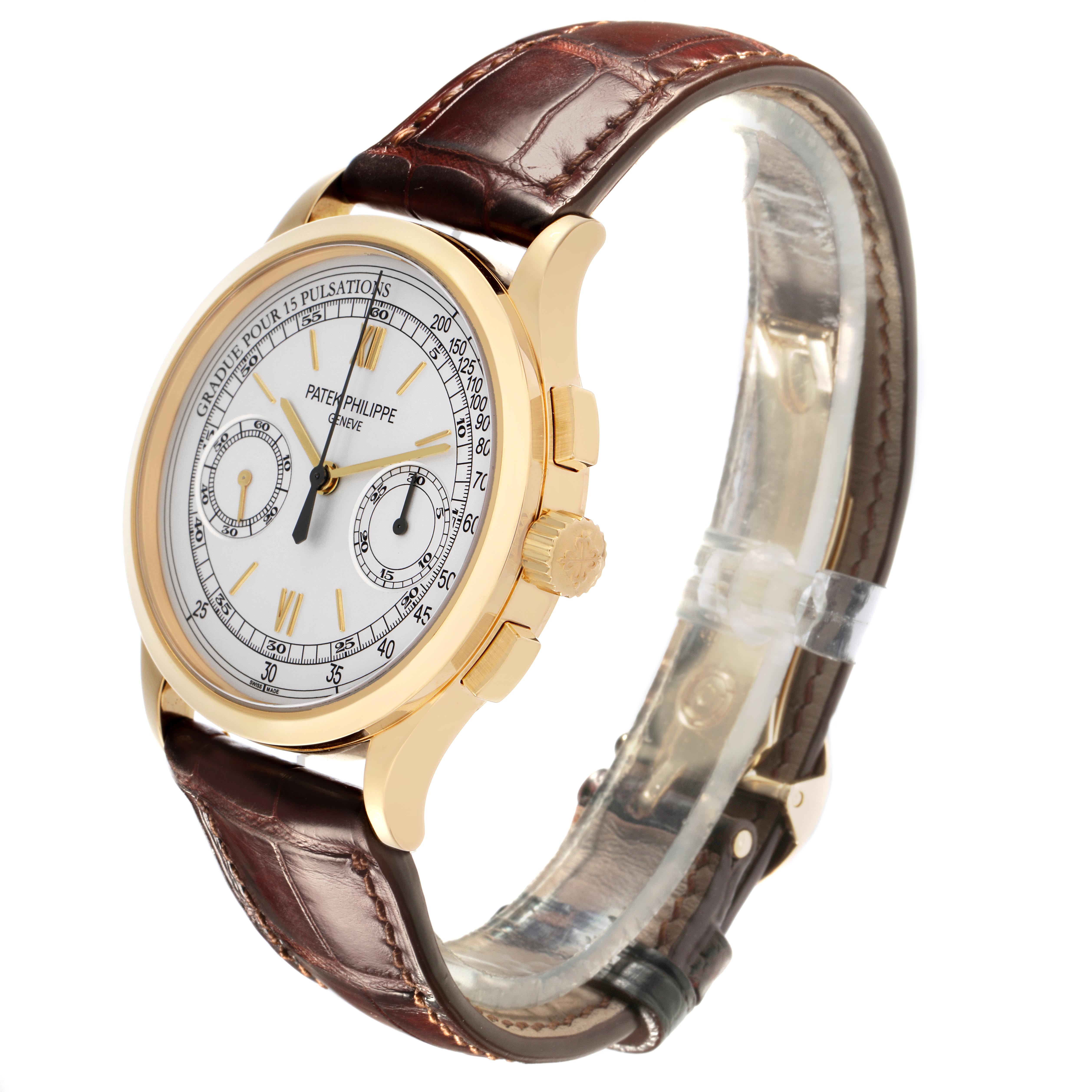 The Patek Philippe Complications 5170J Men
s Yellow Gold Silver Dial 5170J Men
s Yellow Gold Silver Dial watch is shown at a three-quarter angle, highlighting the dial, crown, and leather strap.