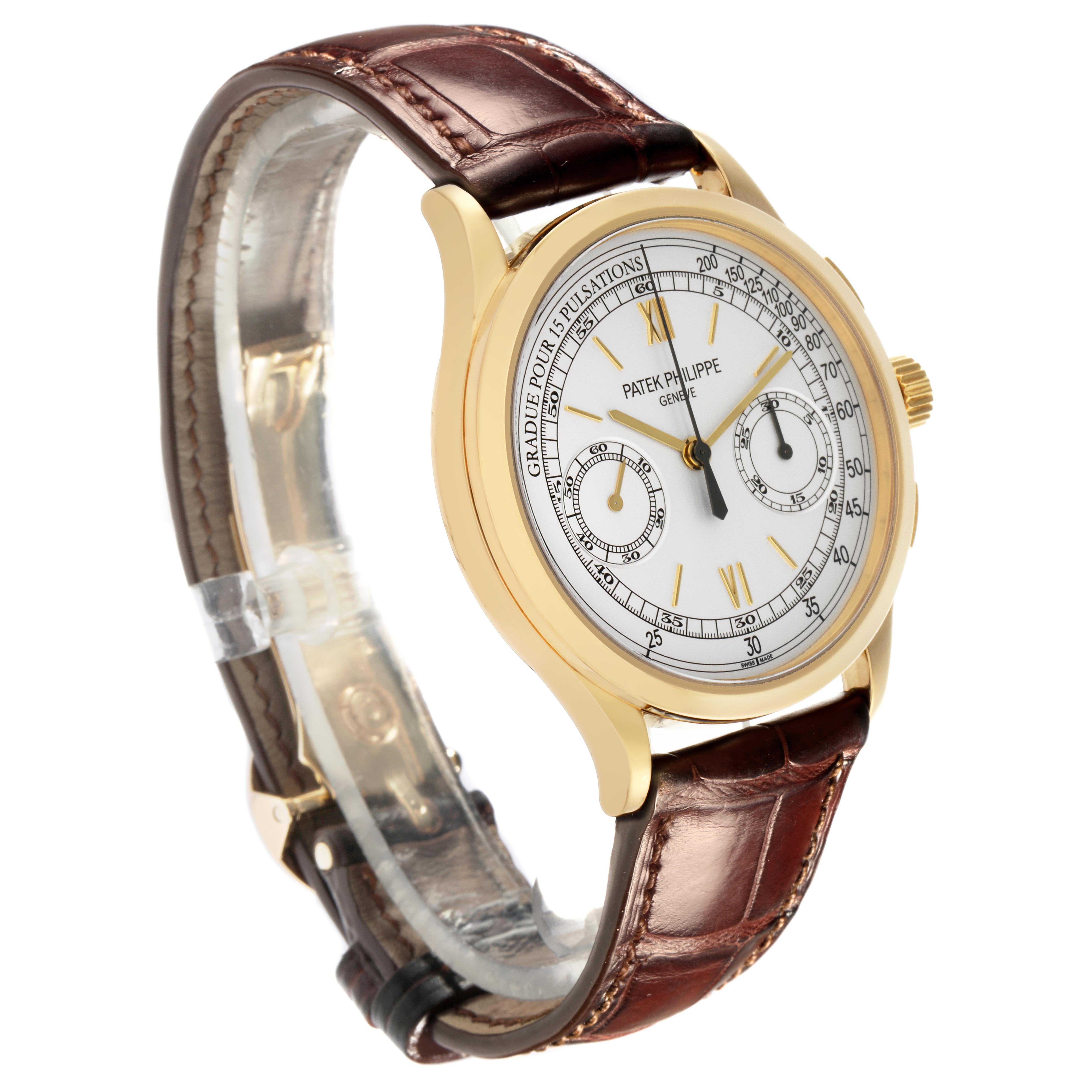 The Patek Philippe Complications 5170J Men
s Yellow Gold Silver Dial 5170J Men
s Yellow Gold Silver Dial watch is shown at a 3/4 angle, highlighting the case, dial, crown, and leather strap.