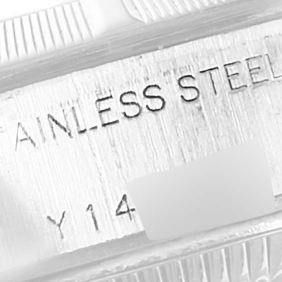 This image shows an engraving on the side of a stainless steel Rolex Date 79190 Women's Stainless Steel Silver Dial 79190 Women's Stainless Steel Silver Dial model watch with partial serial numbers.