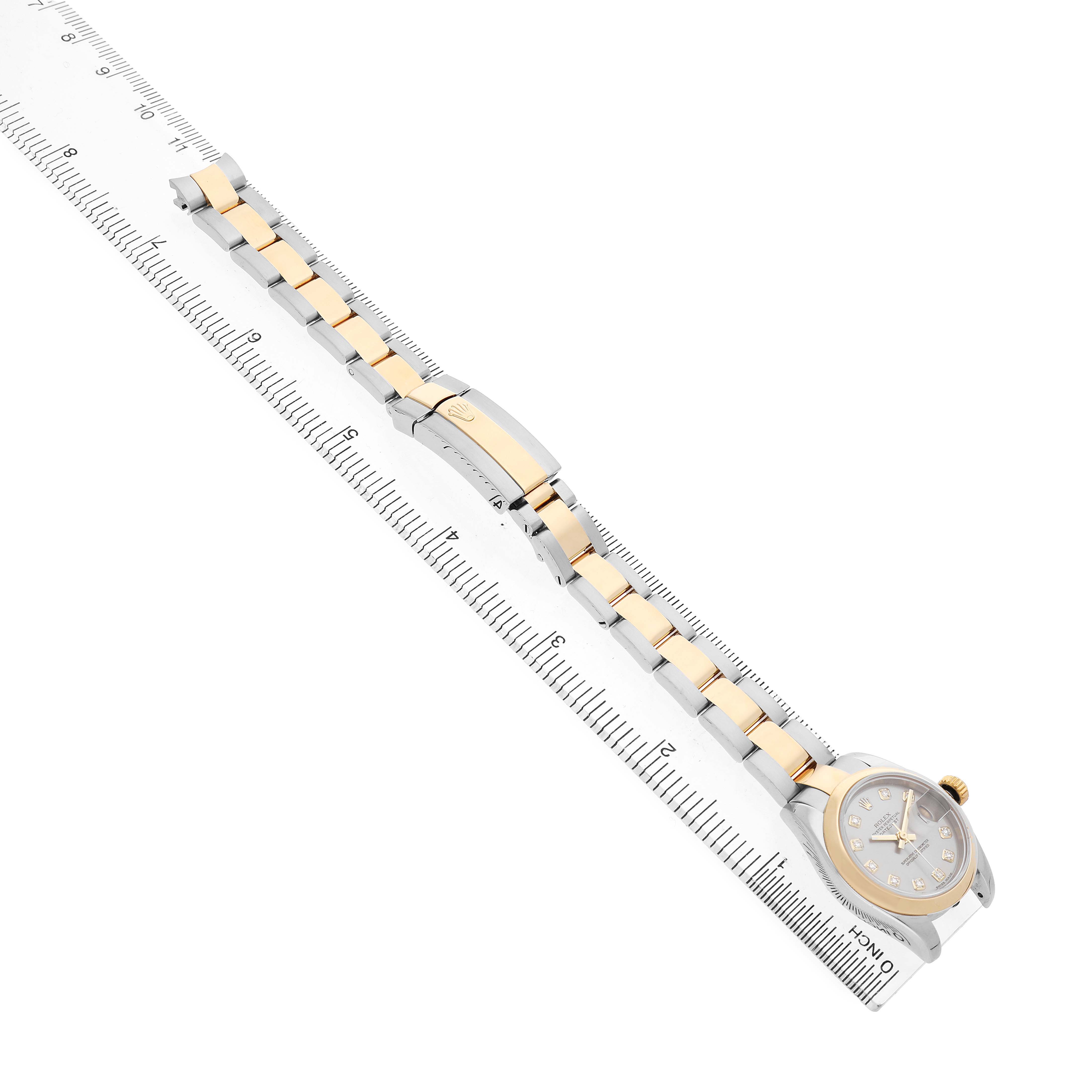 The Rolex Datejust 179163 Women's Stainless Steel Grey Dial watch is displayed diagonally, showcasing the bracelet and clasp, alongside a ruler for size reference.