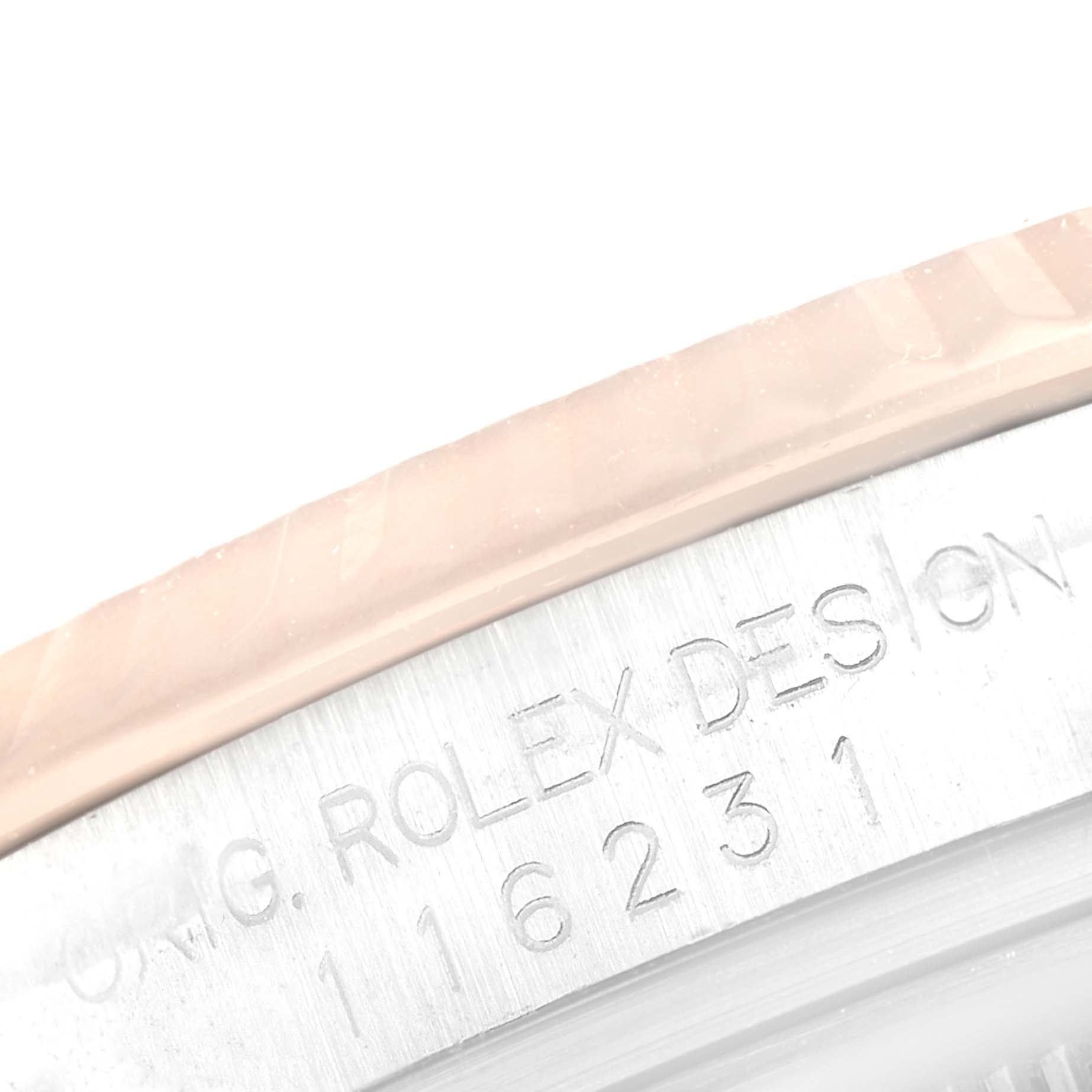 The image shows a close-up angle of the bezel and case edge of a Rolex Datejust 116231 Men's Steel and Gold (two tone) Black Dial 116231 Men's Steel and Gold (two tone) Black Dial, revealing part of its engraved serial number.