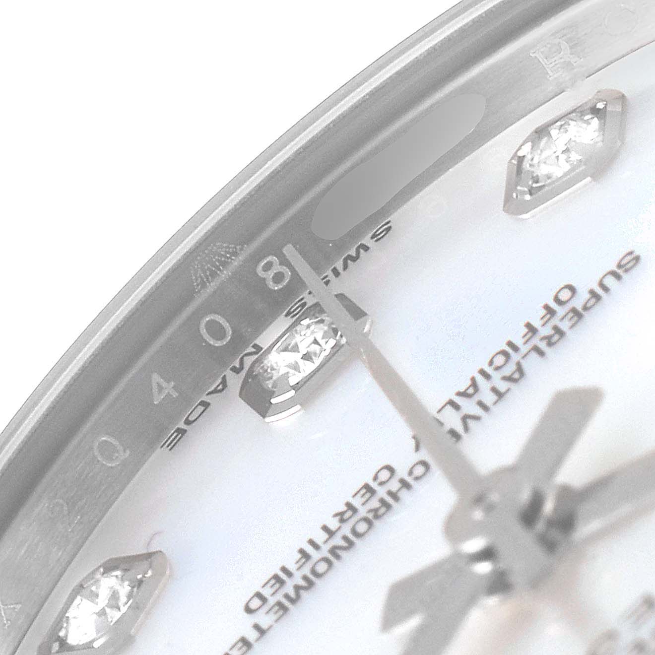 The image shows a close-up angle of a Rolex Mid-Size 178384 Women
s Stainless Steel Mother of Pearl Dial 178384 Women
s Stainless Steel Mother of Pearl Dial watch face, highlighting the diamond hour markers and part of the "SWISS MADE" text.