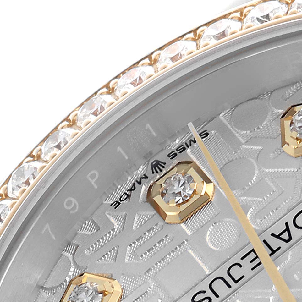 The image shows a close-up of the Rolex Datejust 126283 Men
s Steel and Gold (two tone) Silver Dial 126283 Men
s Steel and Gold (two tone) Silver Dial
s bezel with diamonds, portion of the dial, and part of a baguette hour marker.