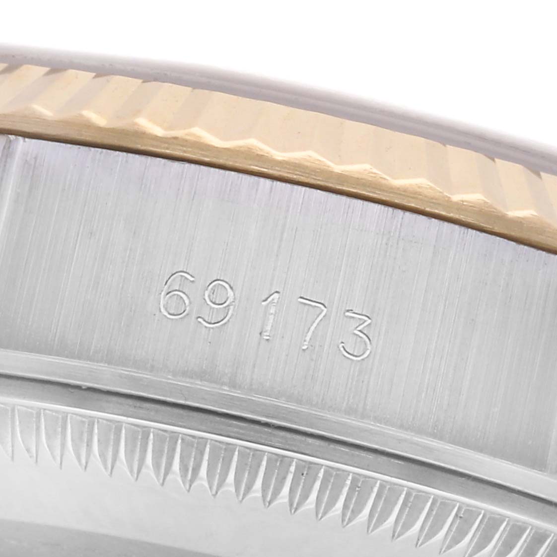The image shows a close-up of the serial number and fluted bezel of a Rolex Datejust 69173 Women's Steel and Gold (two tone) Champagne Dial 69173 Women's Steel and Gold (two tone) Champagne Dial watch.