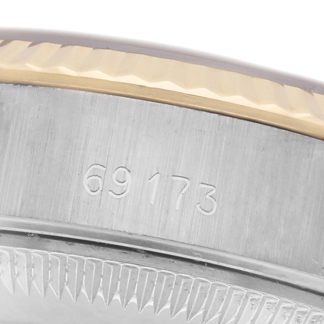 The image shows a close-up of the side of a Rolex Datejust 69173 Women's Steel and Gold (two tone) Champagne Dial 69173 Women's Steel and Gold (two tone) Champagne Dial, focusing on the case edge and engraved model number.