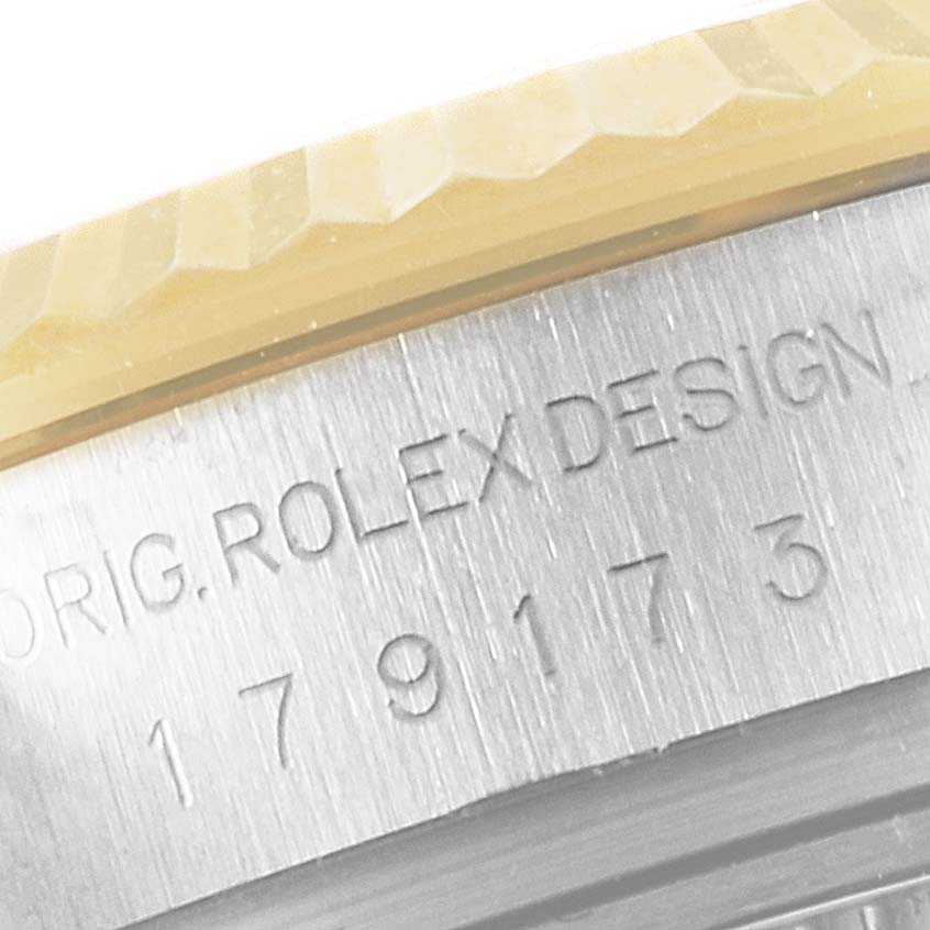 The image shows a close-up of the engraved model number and edge of the fluted bezel of a Rolex Datejust 179173 Women's Steel and Gold (two tone) Mother of Pearl Dial 179173 Women's Steel and Gold (two tone) Mother of Pearl Dial watch.