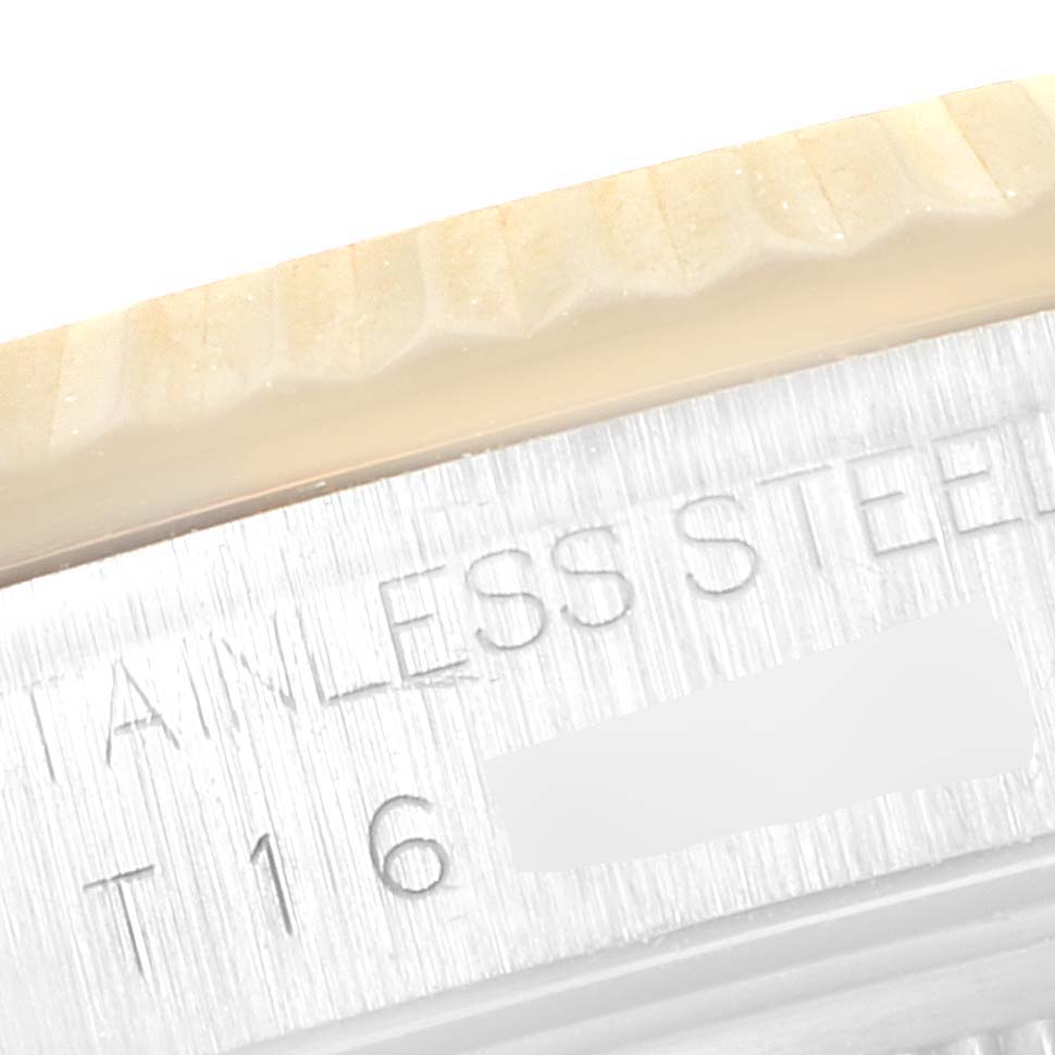 This close-up image shows the engraved edge of the bezel and the case of a Rolex Datejust 16233 Men's Steel and Gold (two tone) Mother of Pearl Dial 16233 Men's Steel and Gold (two tone) Mother of Pearl Dial watch.