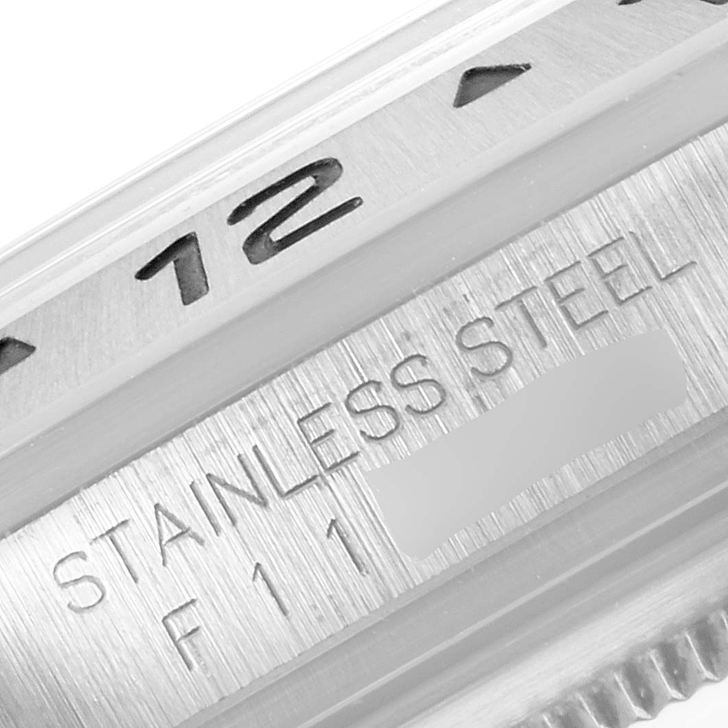 This image shows a close-up of the bezel and case of a Rolex Explorer 16570 Men's Stainless Steel White Dial 16570 Men's Stainless Steel White Dial watch, highlighting "STAINLESS STEEL" etching.