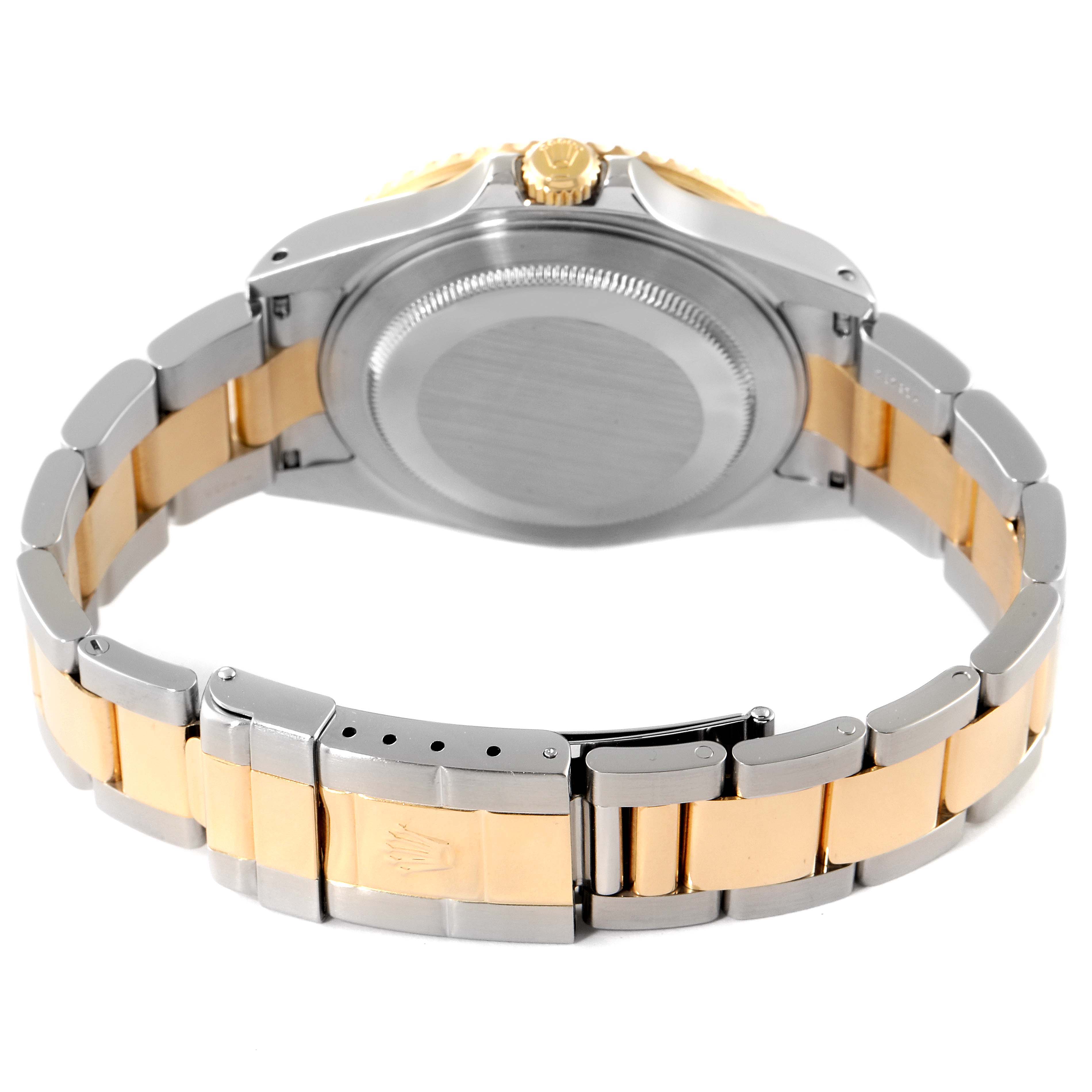 This image shows the back case and bracelet of a Rolex GMT-Master 16713 Men's Steel and Gold (two tone) Black Dial 16713 Men's Steel and Gold (two tone) Black Dial watch, featuring a two-tone metal design.