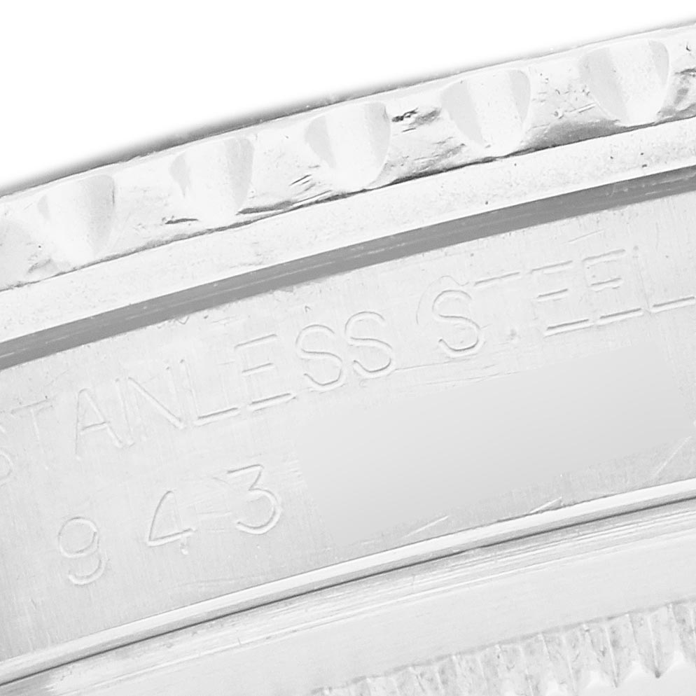 The image shows a close-up of the engraved edge and side of the bezel of a Rolex GMT-Master 16750 Men
s Stainless Steel Black Dial 16750 Men
s Stainless Steel Black Dial watch.
