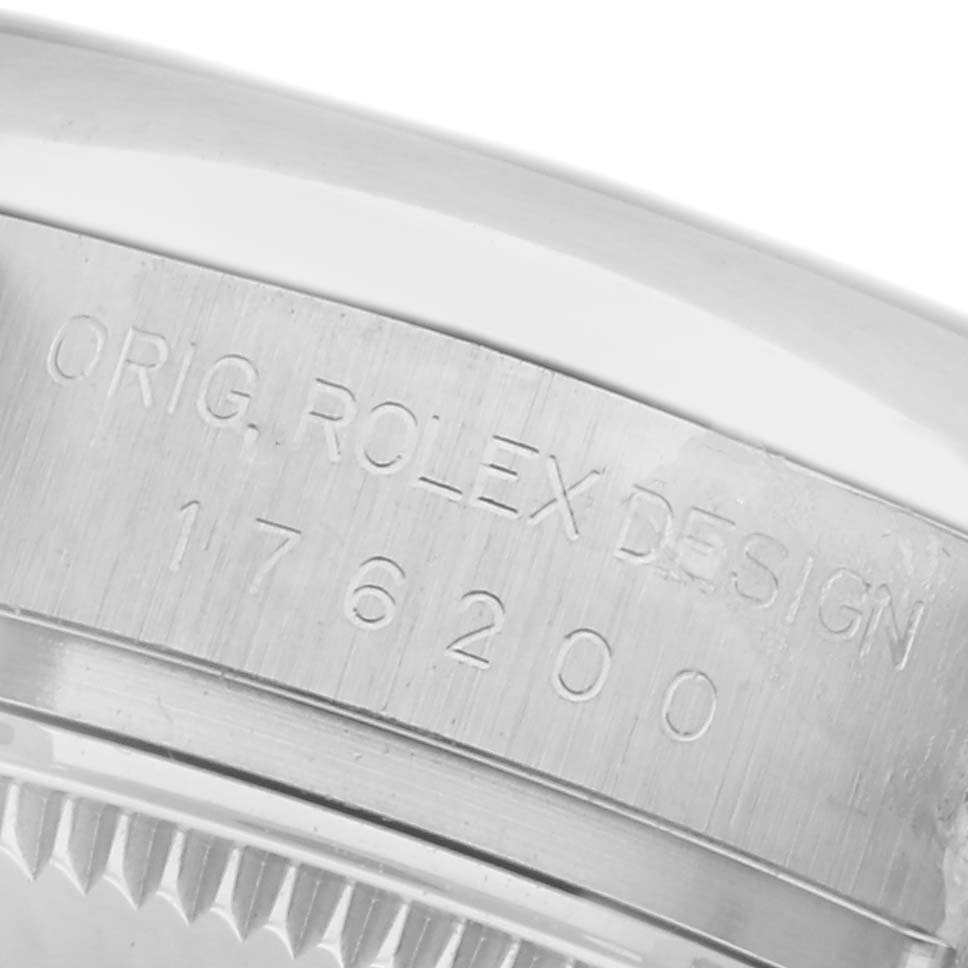 The image shows a close-up of the case edge of a Rolex Oyster Perpetual 176200 Women's Stainless Steel Pink Dial 176200 Women's Stainless Steel Pink Dial, featuring the engraved design and model number.