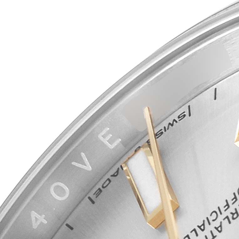 An angled close-up of a Rolex Oyster Perpetual 124200 Men's Stainless Steel Silver Dial 124200 Men's Stainless Steel Silver Dial watch dial, showing part of the face and gold hands.