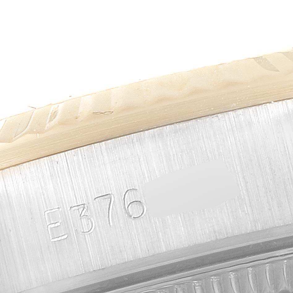 This image shows a close-up of the case side and engraved serial number of a Rolex Oyster Perpetual 67193 Women
s Steel and Gold (two tone) Champagne Dial 67193 Women
s Steel and Gold (two tone) Champagne Dial watch.