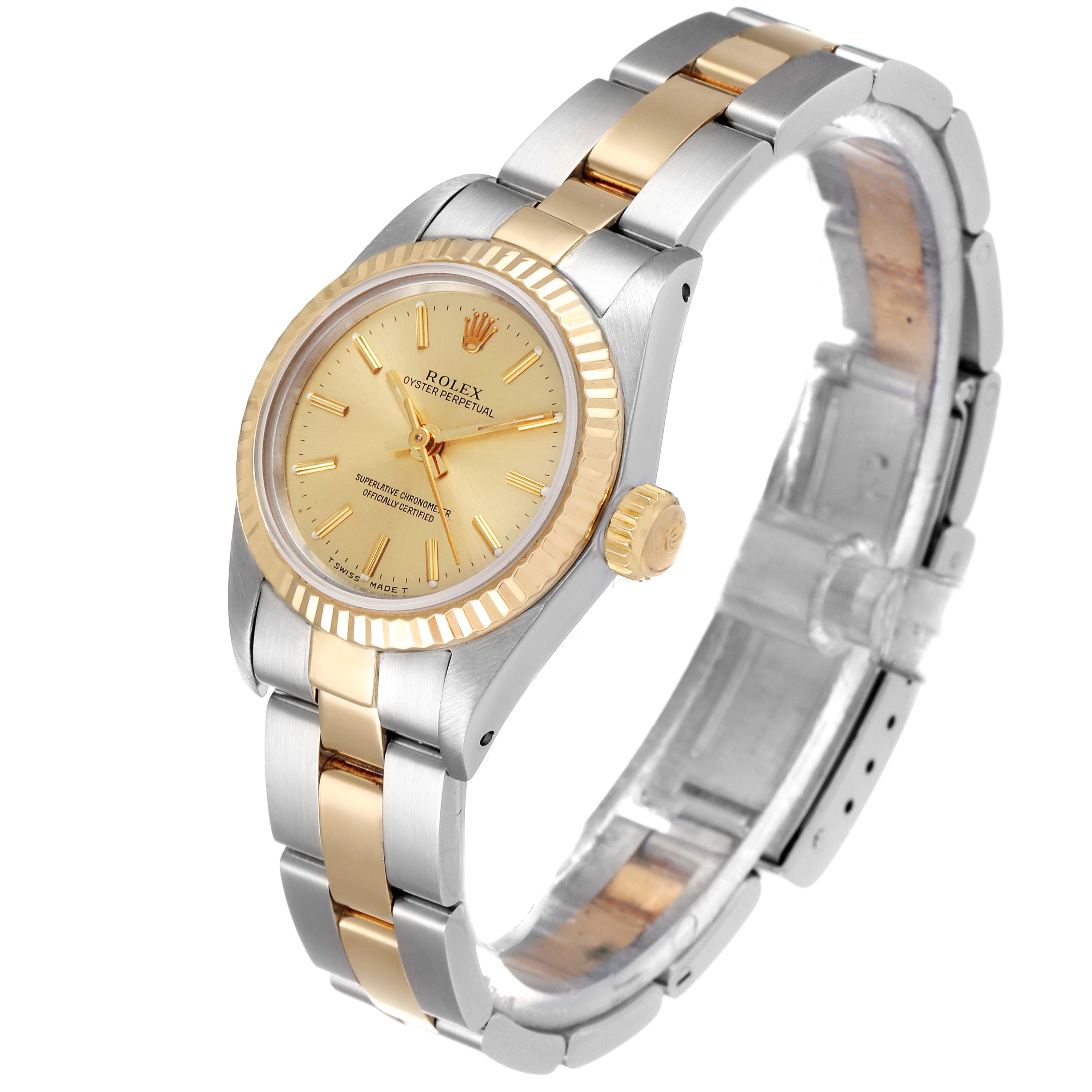 The Rolex Oyster Perpetual 67193 Women
s Steel and Gold (two tone) Champagne Dial 67193 Women
s Steel and Gold (two tone) Champagne Dial watch is shown at a slight angle, displaying its gold and silver bracelet, bezel, crown, and face.
