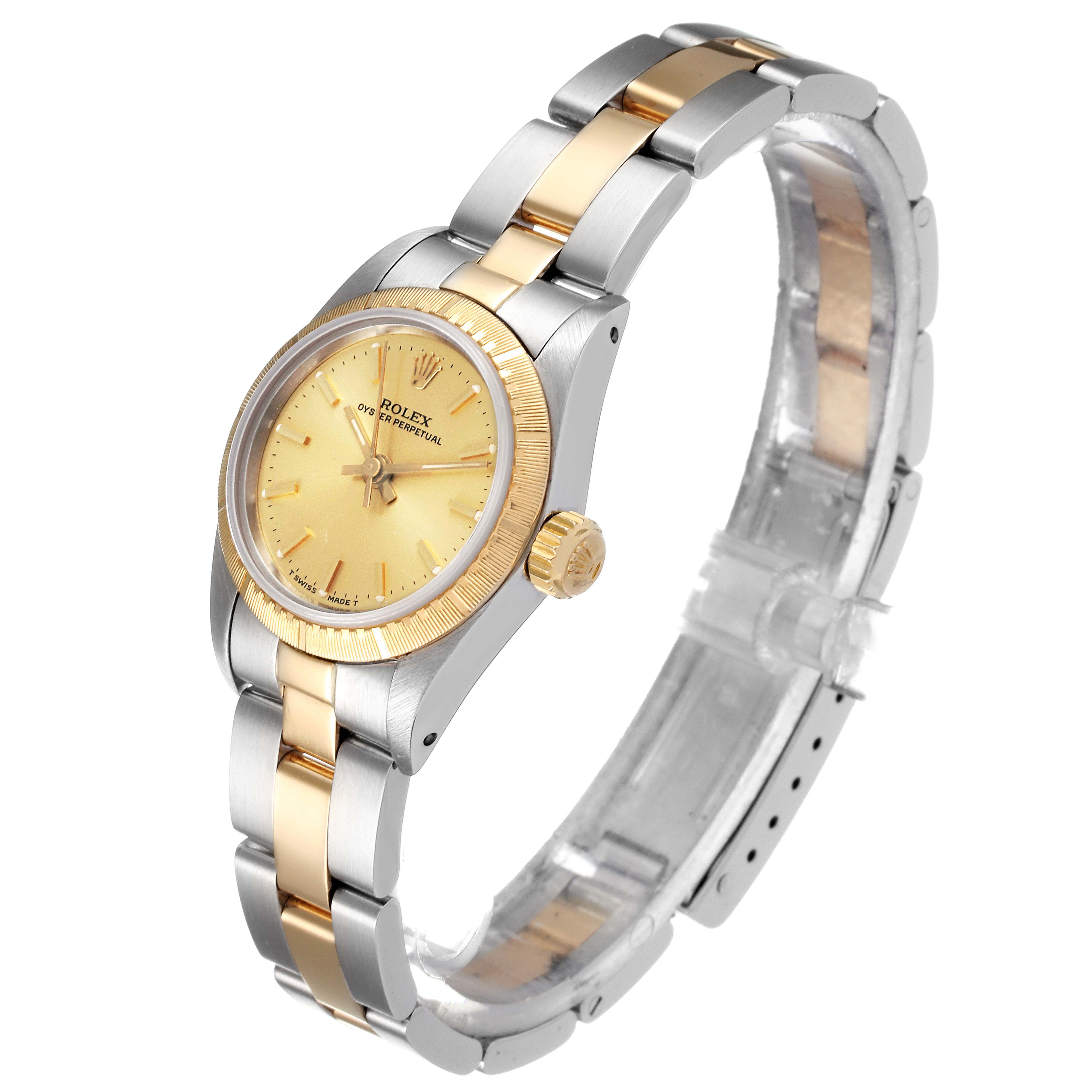 This image shows a side angle of the Rolex Oyster Perpetual 67243 Women
s Steel and Gold (two tone) Champagne Dial 67243 Women
s Steel and Gold (two tone) Champagne Dial watch, highlighting the face, crown, and bracelet.