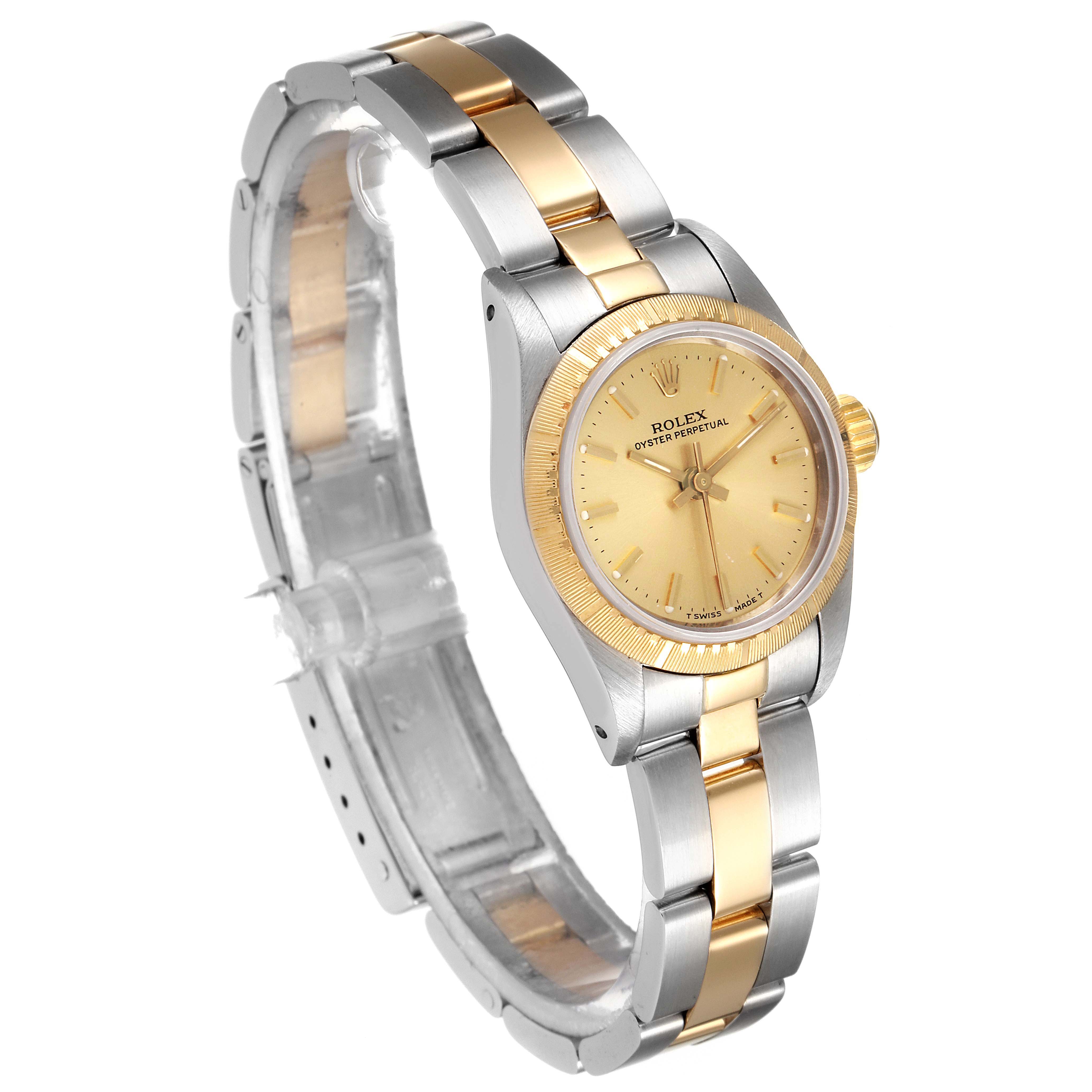 This image shows a Rolex Oyster Perpetual 67243 Women
s Steel and Gold (two tone) Champagne Dial 67243 Women
s Steel and Gold (two tone) Champagne Dial watch from a three-quarter angle, highlighting its bezel, dial, and two-tone bracelet.