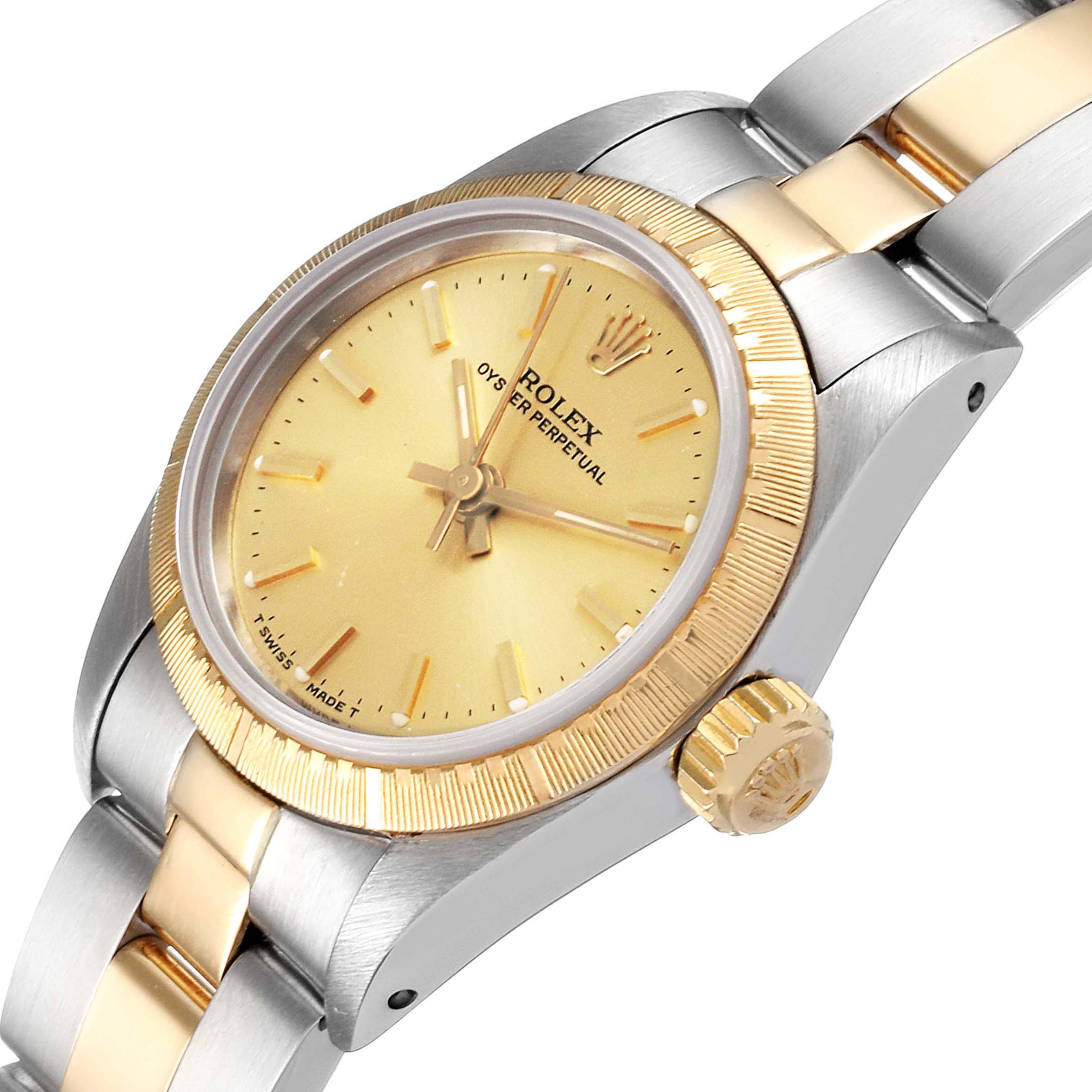 The image shows a side angle of a Rolex Oyster Perpetual 67243 Women
s Steel and Gold (two tone) Champagne Dial 67243 Women
s Steel and Gold (two tone) Champagne Dial watch, highlighting its face, crown, bezel, and bracelet.
