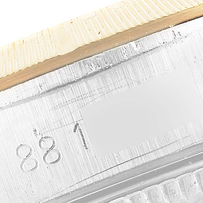 This close-up image shows the engraved numbers on the case side of a Rolex Oyster Perpetual 67243 Women
s Steel and Gold (two tone) Champagne Dial 67243 Women
s Steel and Gold (two tone) Champagne Dial watch.