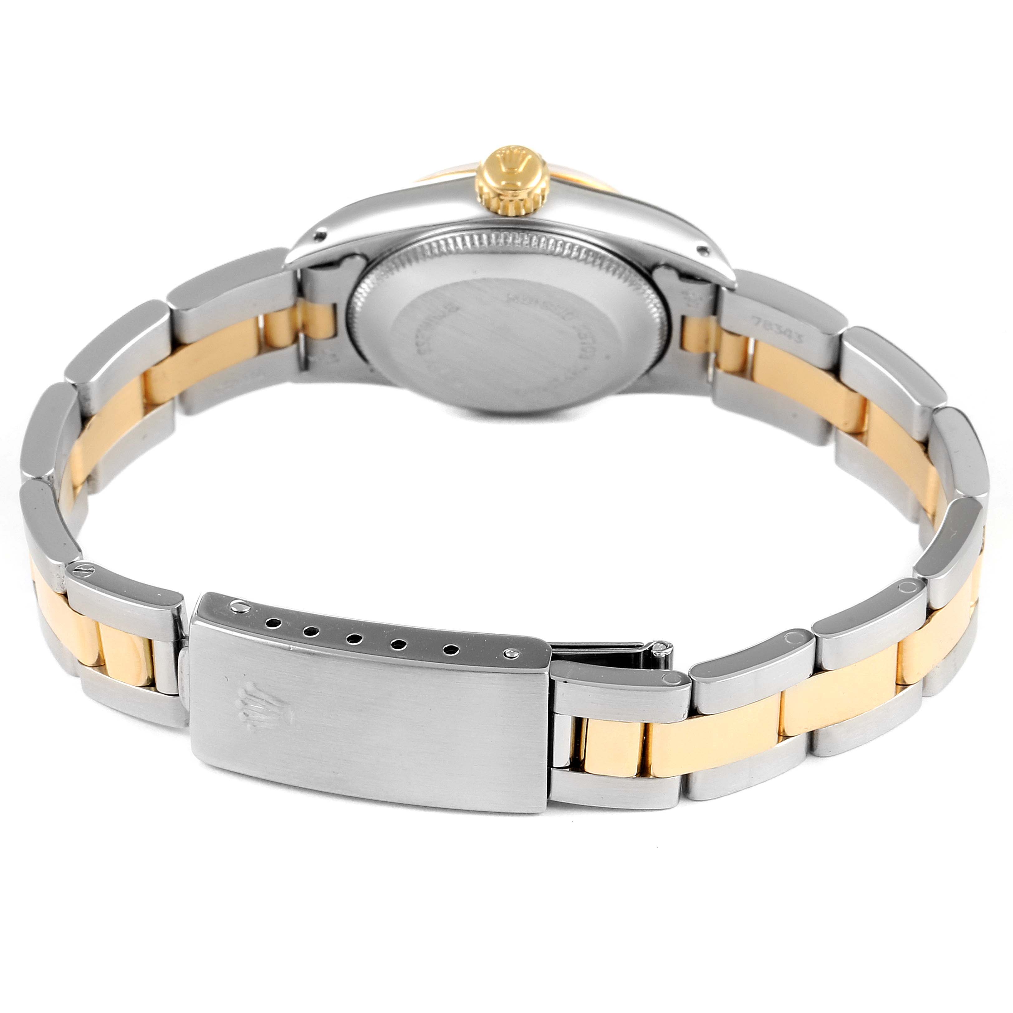 This image shows the back and the bracelet of a Rolex Oyster Perpetual 67243 Women
s Steel and Gold (two tone) Champagne Dial 67243 Women
s Steel and Gold (two tone) Champagne Dial watch, featuring two-tone metal links and a closed clasp.