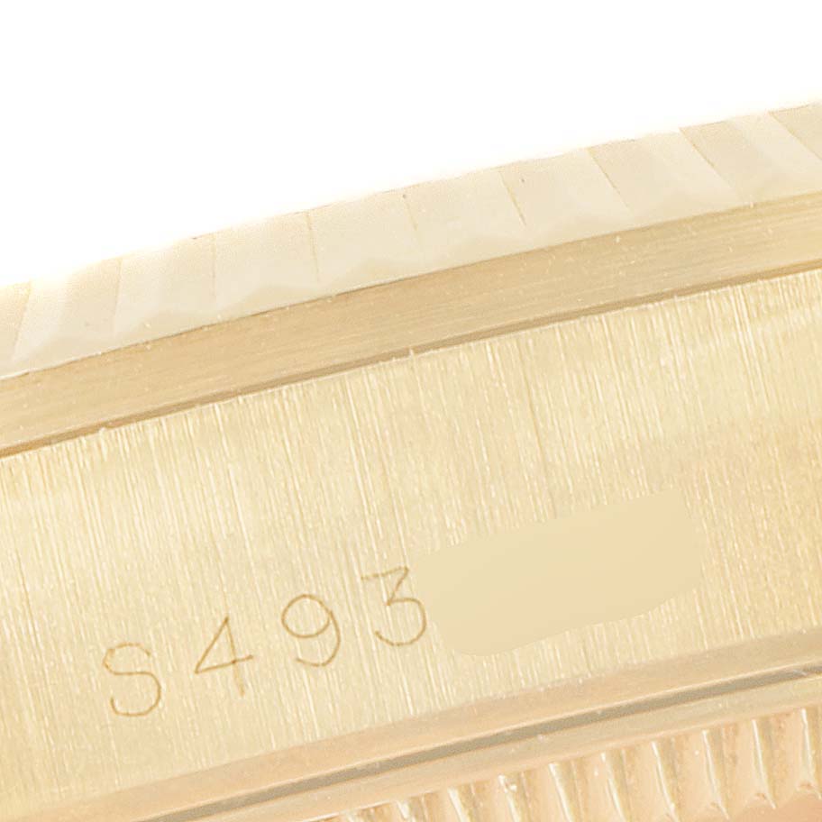 This image shows a close-up view of the Rolex President 68278 Women
s Yellow Gold Champagne Dial 68278 Women
s Yellow Gold Champagne Dial model
s case serial number engraving.