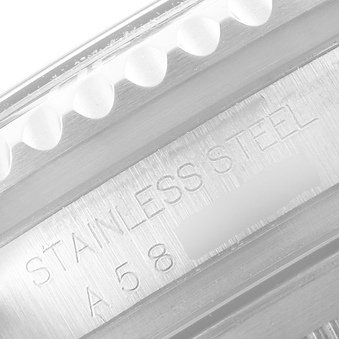 This close-up image shows the engraved edge and the "STAINLESS STEEL" marking on the case of a Rolex Sea-Dweller 16600 Men
s Stainless Steel Black Dial 16600 Men
s Stainless Steel Black Dial watch.