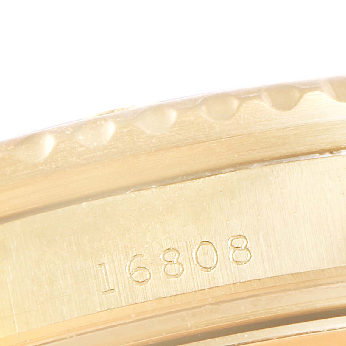 This close-up image shows the engraved reference number 16808 on the side of the Rolex Submariner 16808 Men's Yellow Gold Black Dial 16808 Men's Yellow Gold Black Dial watch case.