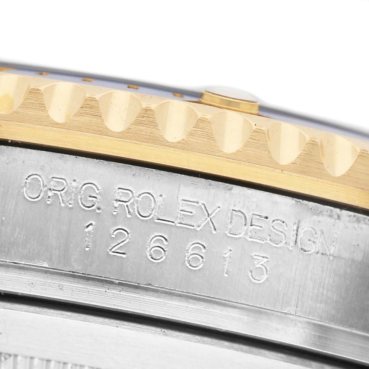 The image shows a close-up of the side of a Rolex Submariner M126613LB-0002 Men's Stainless Steel Blue Dial, featuring the metallic case and engraved model number "126613."