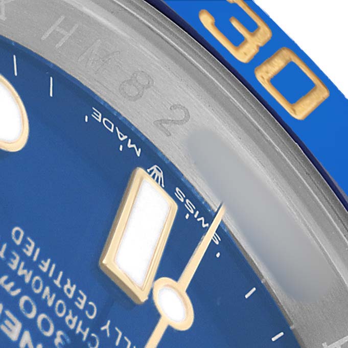 The image shows a close-up of the Rolex Submariner 126613LB Men's Stainless Steel Blue Dial's blue dial and bezel, with visible indices and minute hand.