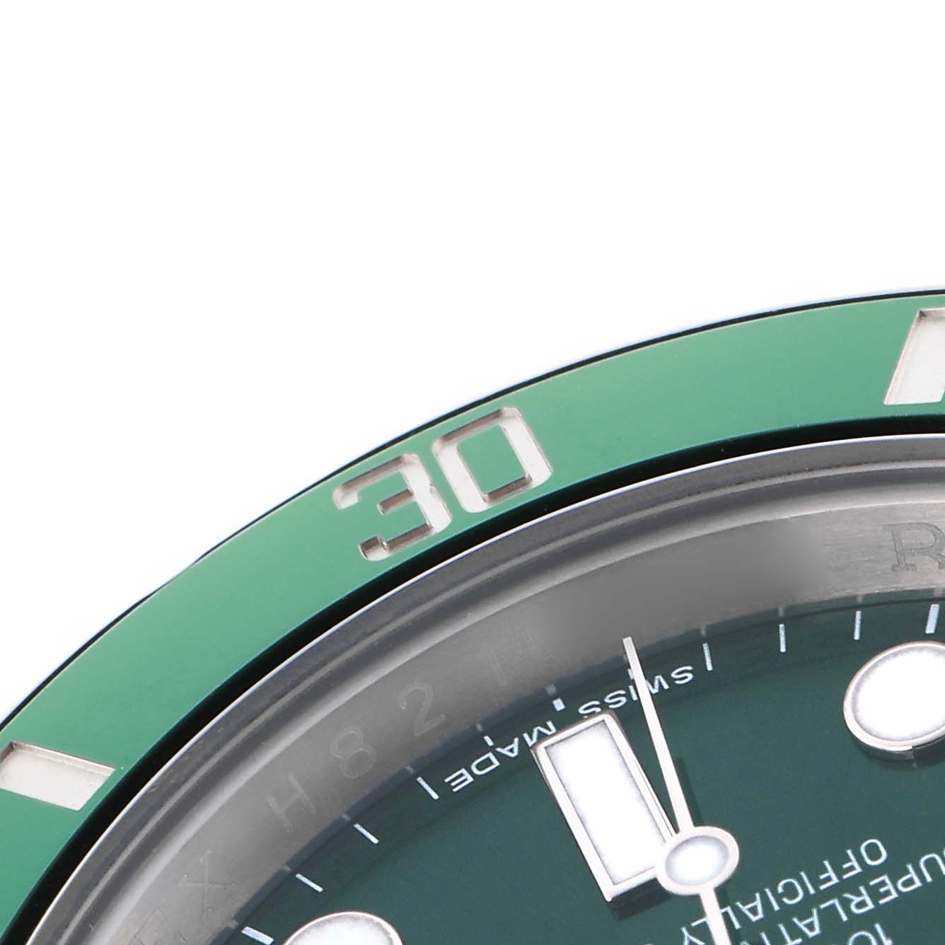 The image shows a close-up of the Rolex Submariner 116610LV Men
s Stainless Steel Green Dial 116610LV Men
s Stainless Steel Green Dial
s bezel and partial dial, focusing on the number "30" and part of the hour markers.