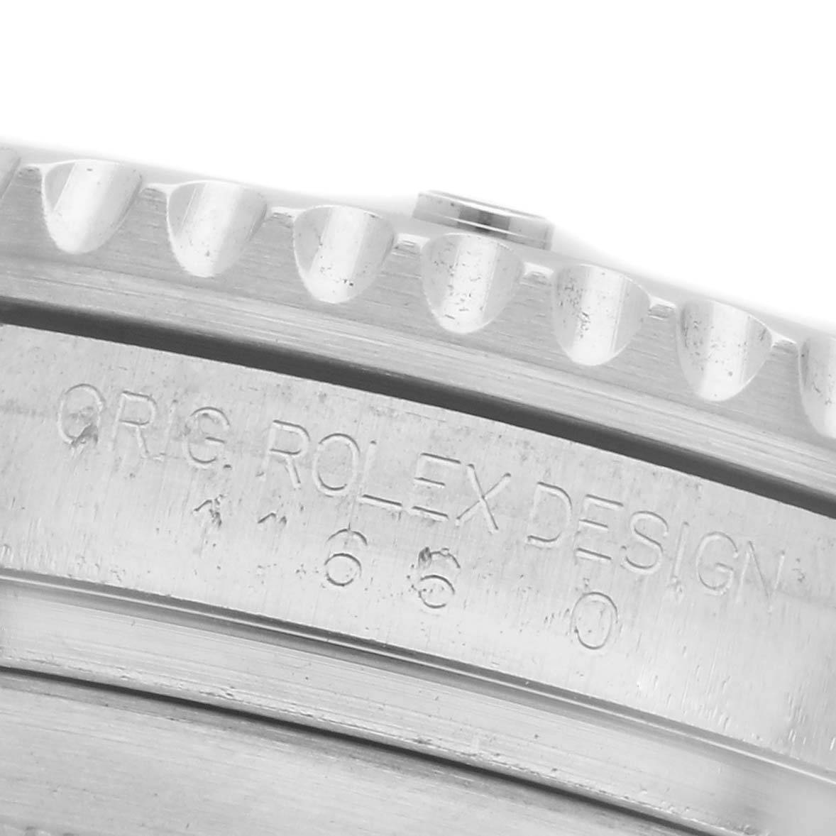 The image shows a close-up angle of the bezel and case side of a Rolex Submariner 116610LV Men
s Stainless Steel Green Dial 116610LV Men
s Stainless Steel Green Dial, highlighting the engraved "ORIG ROLEX DESIGN."