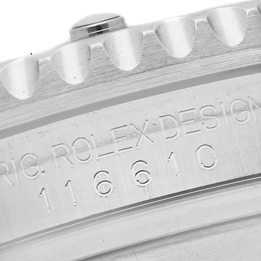 The image shows a close-up of the edge of a Rolex Submariner 116610LV Men
s Stainless Steel Green Dial 116610LV Men
s Stainless Steel Green Dial bezel and engraved model number.