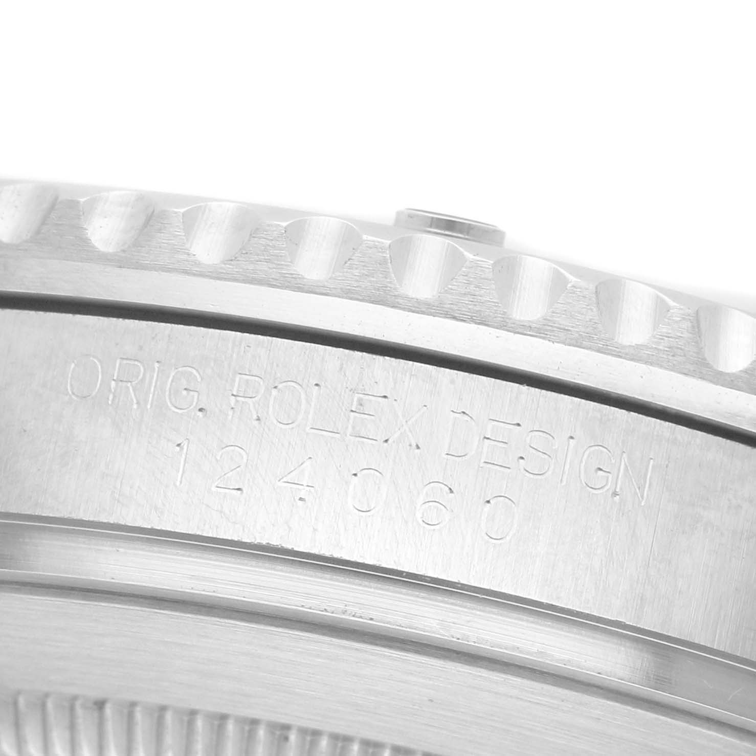 The image shows a close-up of the bezel and side engraving on a Rolex Submariner M124060-0001 Men's Stainless Steel Black Dial watch.