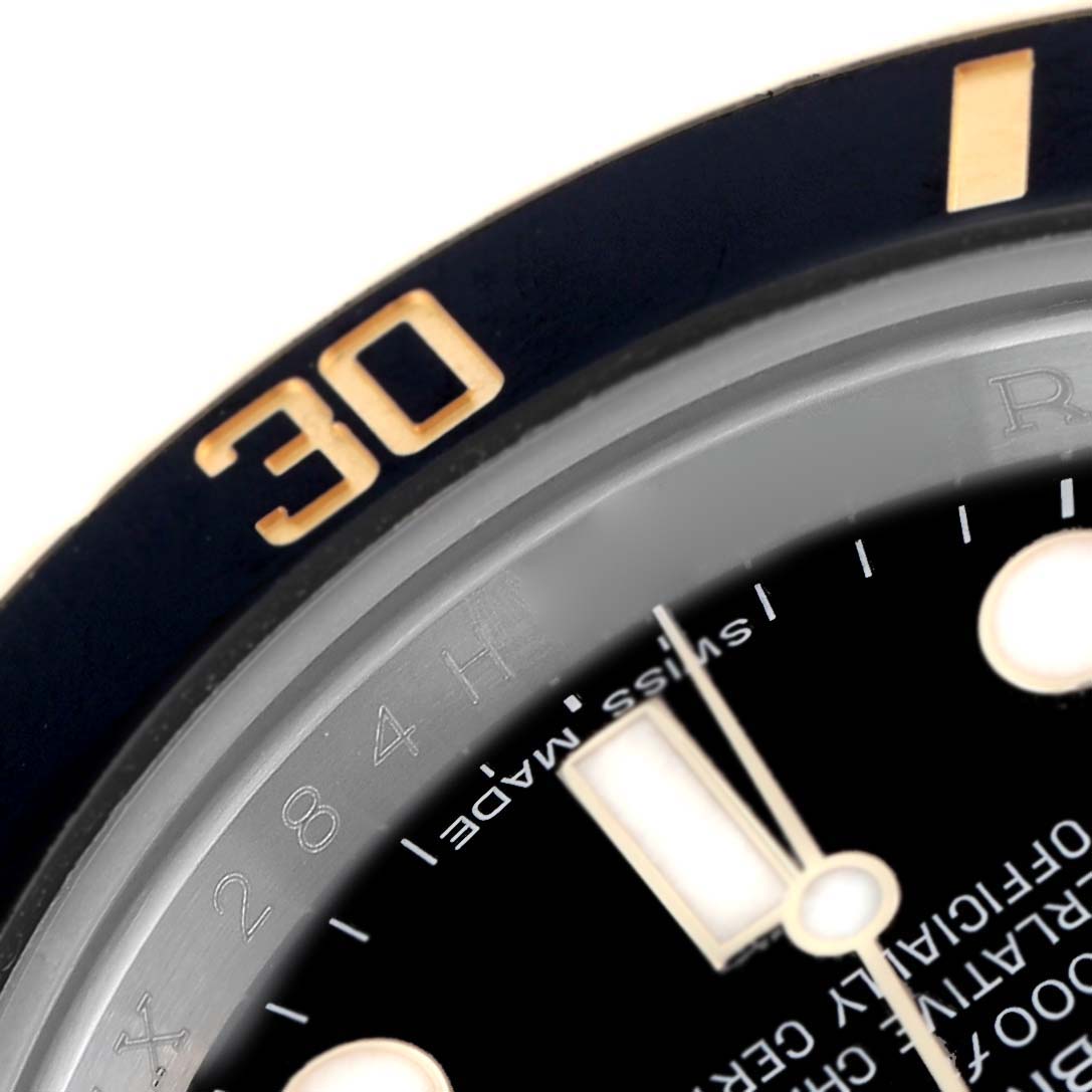 The image shows a close-up of the Rolex Submariner 116613 Men
s Steel and Gold (two tone) Black Dial 116613 Men
s Steel and Gold (two tone) Black Dial
s bezel and part of its dial, highlighting the 30-minute mark.