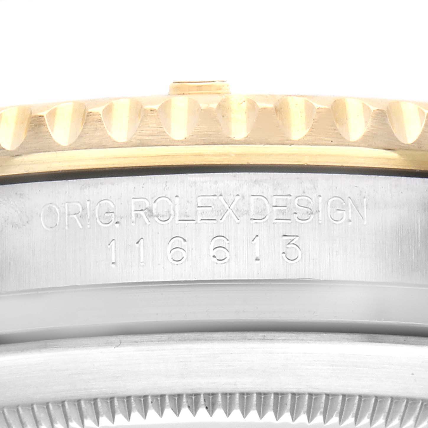 The image shows the side of a Rolex Submariner 116613 Men
s Steel and Gold (two tone) Black Dial 116613 Men
s Steel and Gold (two tone) Black Dial, highlighting the bezel edge and engraved model number.