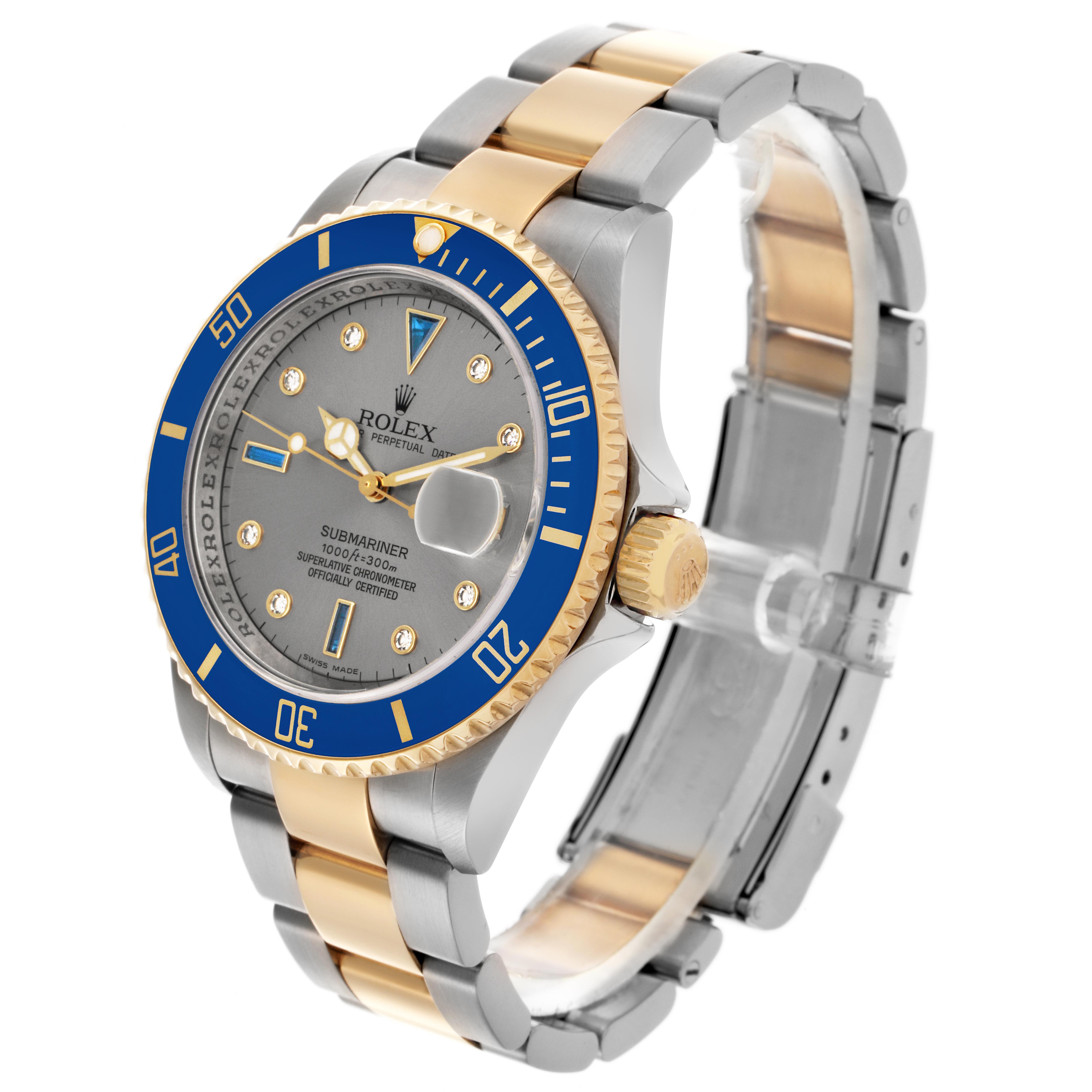 The Rolex Submariner 16613 Men
s Steel and Gold (two tone) Silver Dial 16613 Men
s Steel and Gold (two tone) Silver Dial watch is shown at a three-quarter angle, highlighting its blue bezel, gold accents, and metal bracelet.