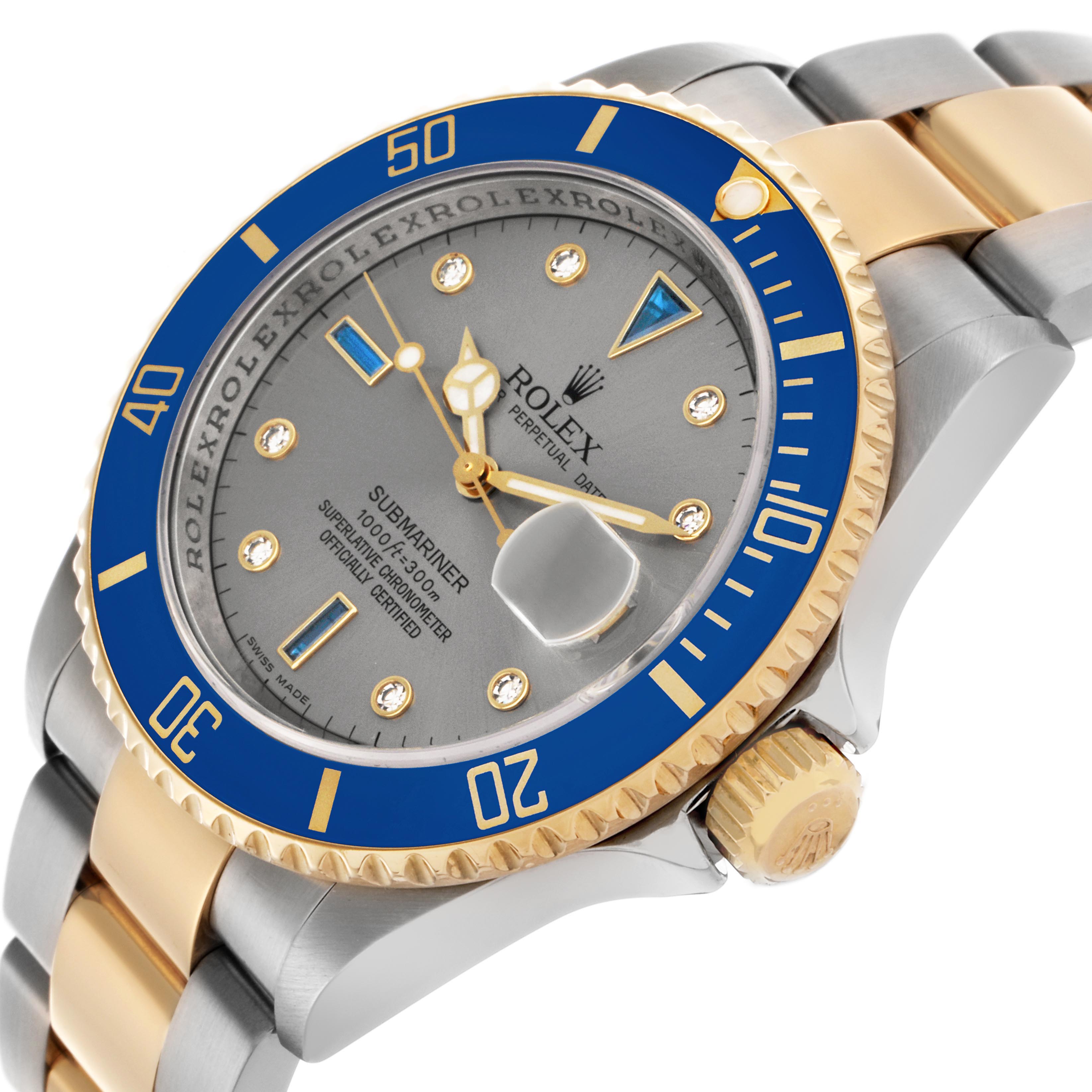 The Rolex Submariner 16613 Men
s Steel and Gold (two tone) Silver Dial 16613 Men
s Steel and Gold (two tone) Silver Dial watch is shown at an angle highlighting the blue and gold bezel, dial, and part of the bracelet.