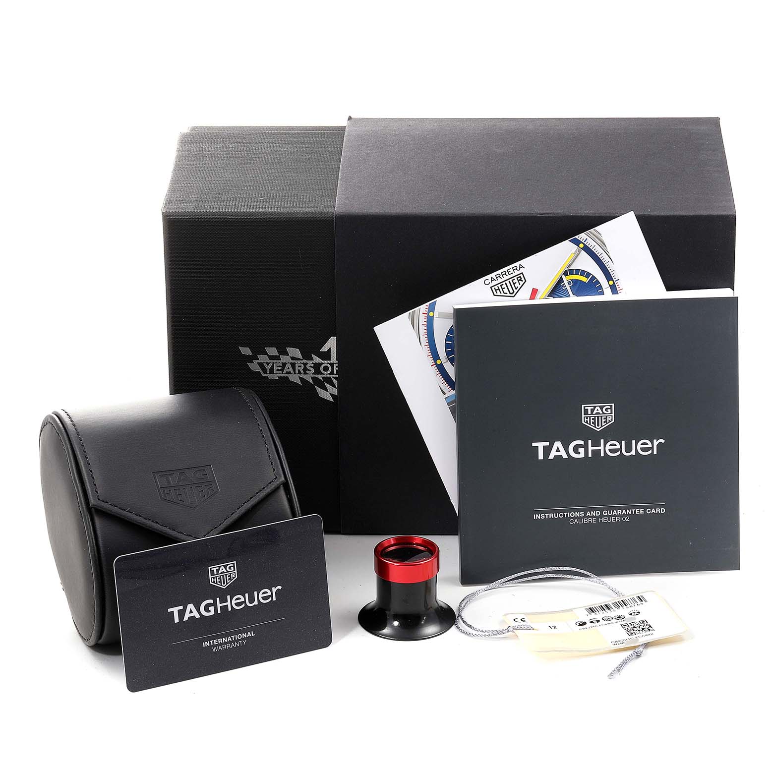 The image shows the packaging and accessories for a Tag Heuer Carrera CBK221C.FC6488 Men's Stainless Steel White Dial CBK221C.FC6488 Men's Stainless Steel White Dial watch, including a warranty card, manual, and loupe.