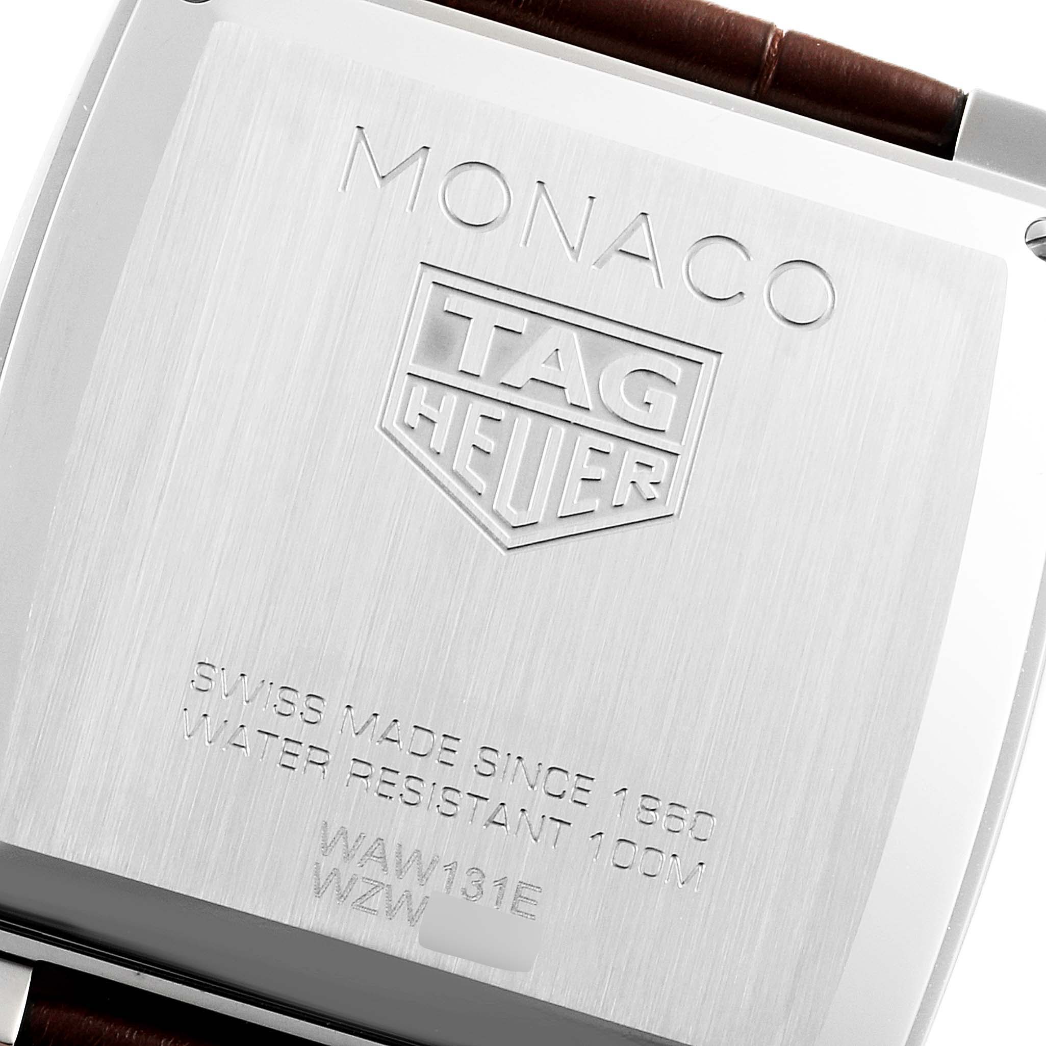 The image shows the back casing of a Tag Heuer Monaco WAW131E.FC6420 Men's Stainless Steel Brown Dial WAW131E.FC6420 Men's Stainless Steel Brown Dial watch, highlighting the branding and model inscriptions.