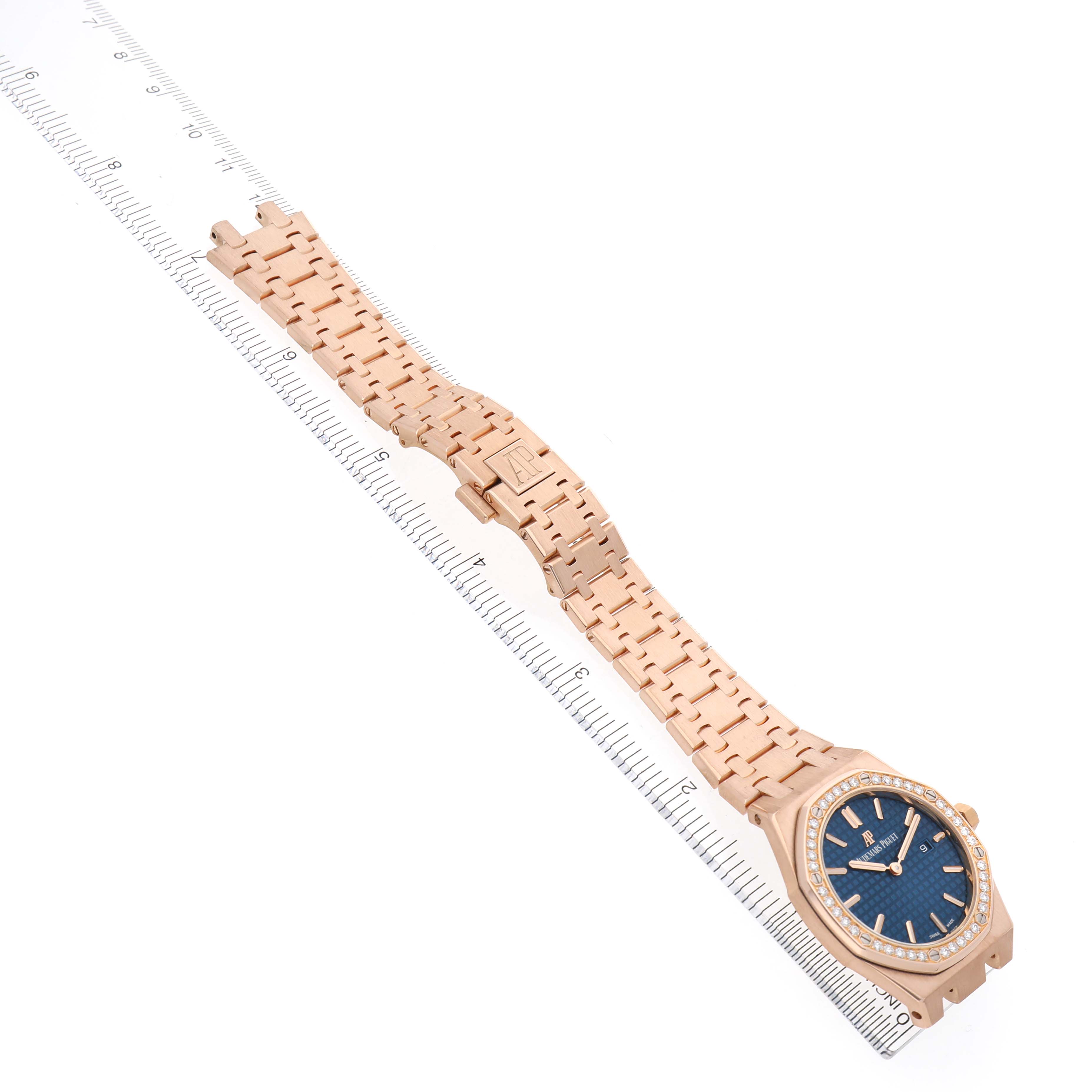 The Audemars Piguet Royal Oak 67651OR.ZZ.1261OR.02 Women's Rose Gold Blue Dial watch is displayed diagonally, showcasing the bracelet, closed clasp, and dial from a top view.