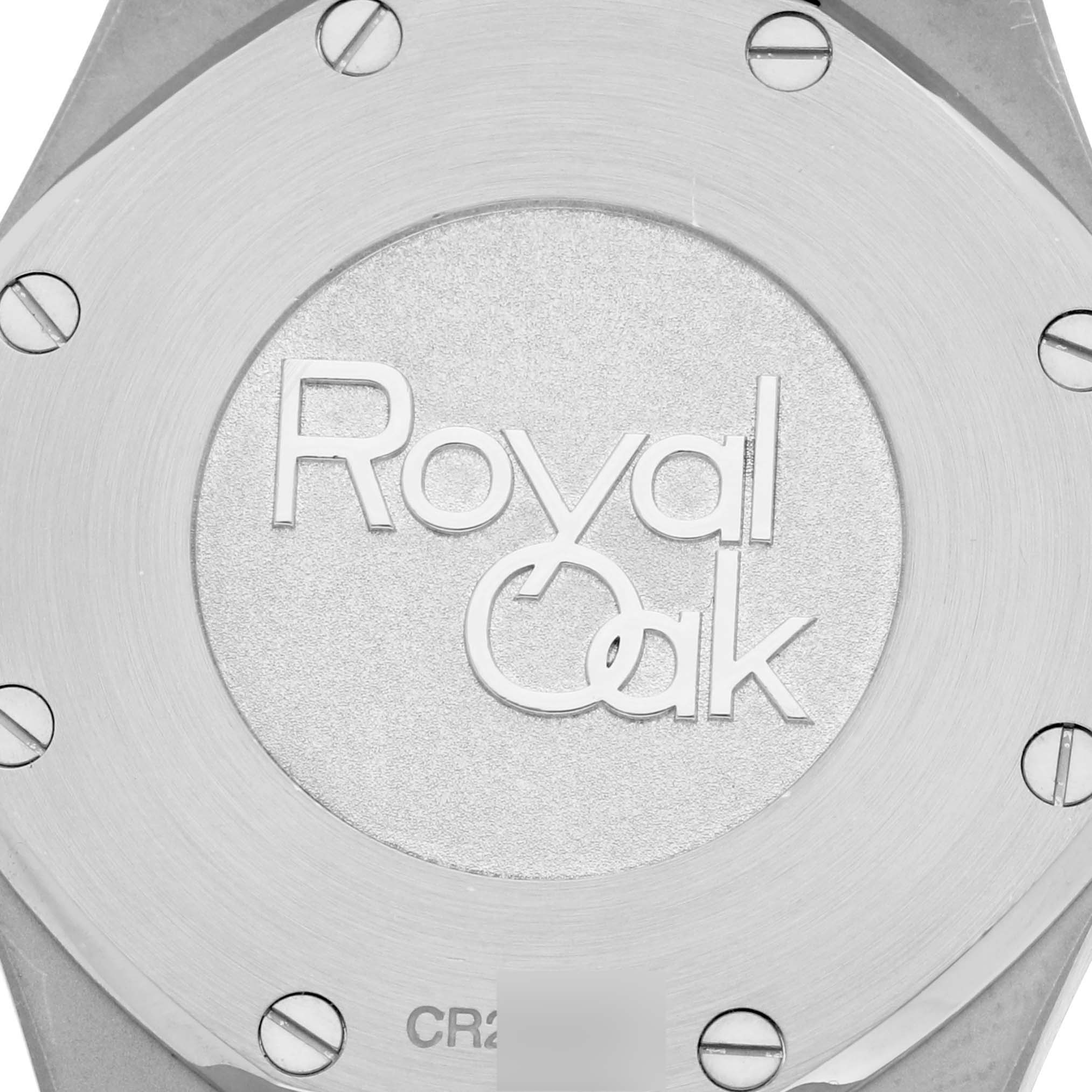 The image shows the back case of a Royal Oak watch by Audemars Piguet, highlighting the engraved logo and securing screws.