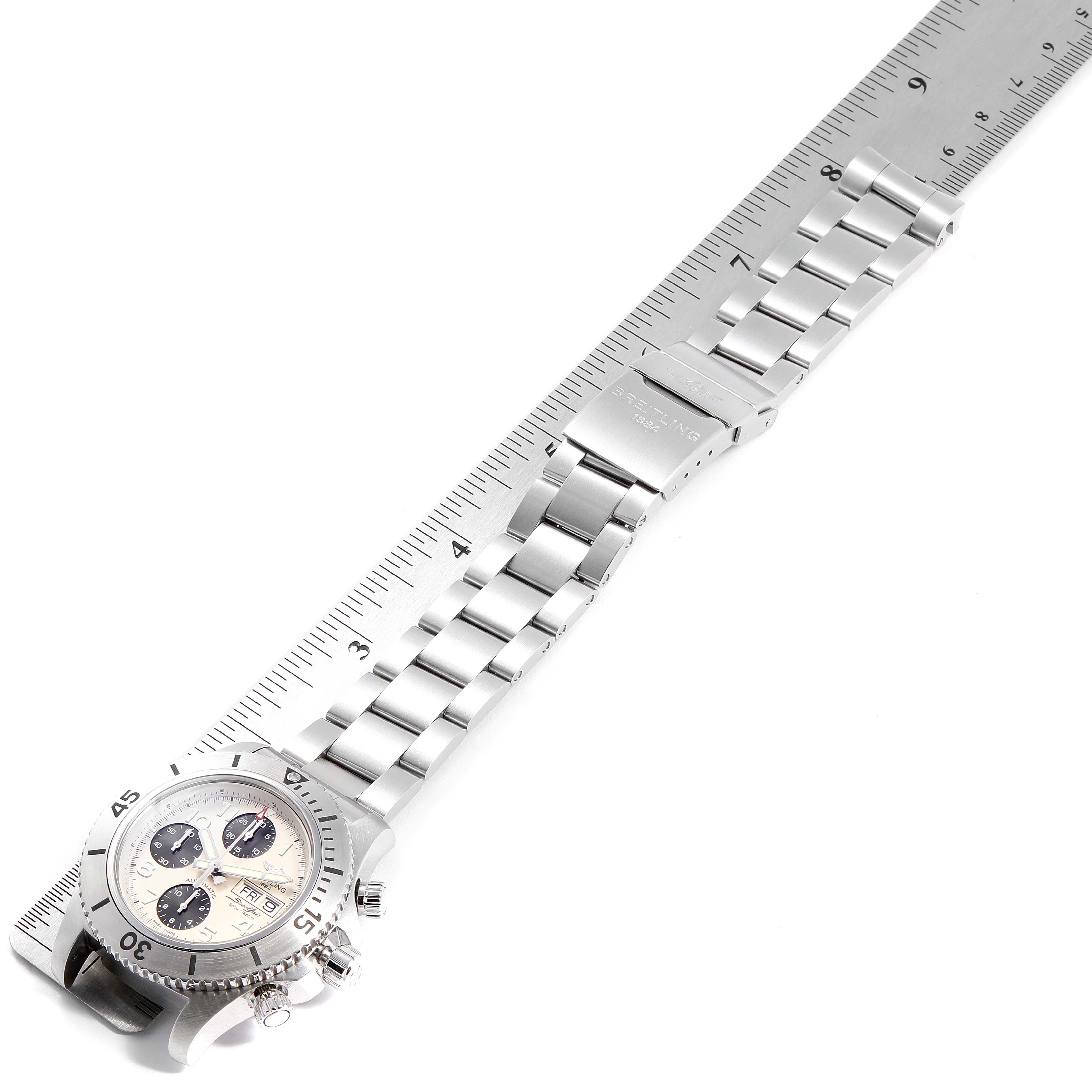 The image shows a Breitling Superocean A13341C3/BD19 Men's Stainless Steel White Dial A13341C3/BD19 Men's Stainless Steel White Dial watch laid flat, with the face, crown, and stainless steel bracelet visible, next to a ruler.