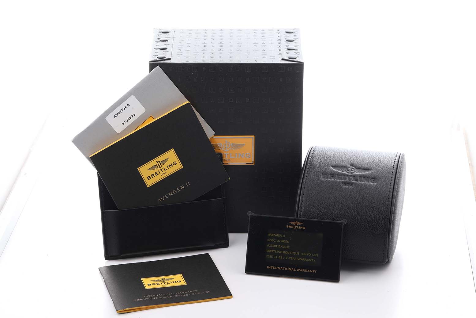 The image shows a Breitling Avenger A13381 Men
s Stainless Steel Black Dial A13381 Men
s Stainless Steel Black Dial watch box, instruction manuals, warranty card, and a watch case.