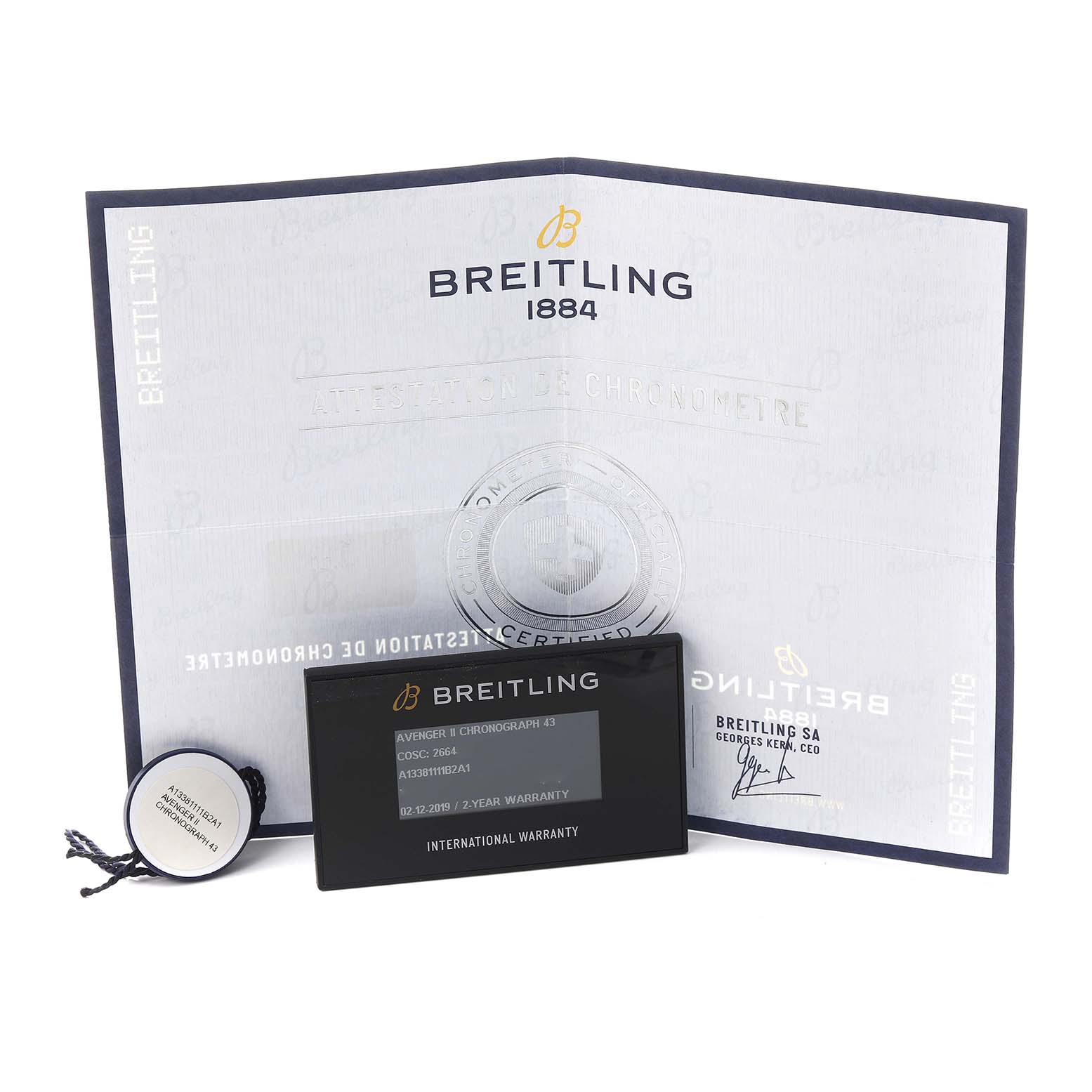 The image shows Breitling Avenger A13381111B2A1 Men's Stainless Steel Black Dial A13381111B2A1 Men's Stainless Steel Black Dial accessories, including a warranty card, tag, and certificate at a slight angle.