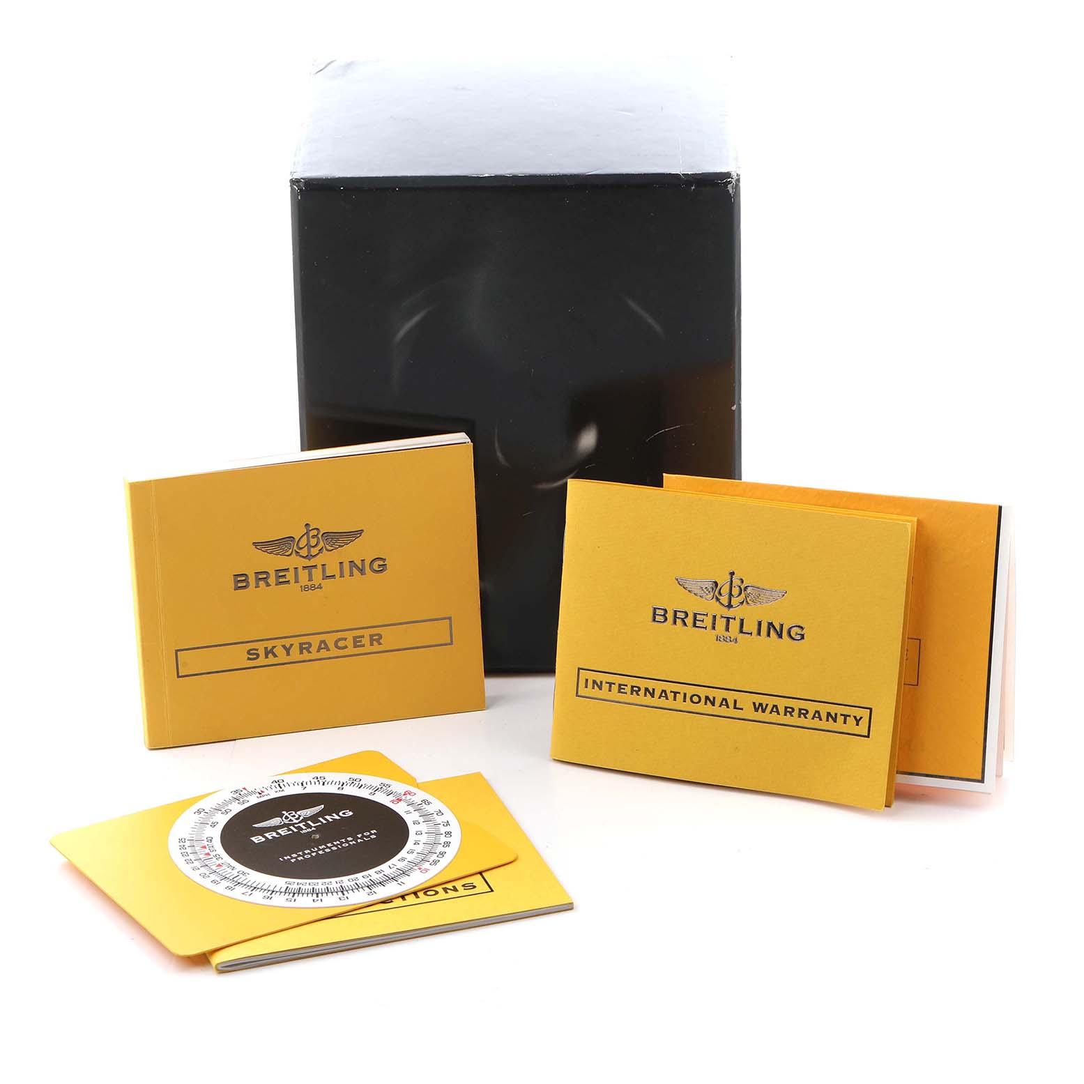 The image shows Breitling Professional Series A27362 Men
s Stainless Steel Silver Dial A27362 Men
s Stainless Steel Silver Dial accessories, including a Skyracer booklet, warranty card, and a slide rule, angled from above.